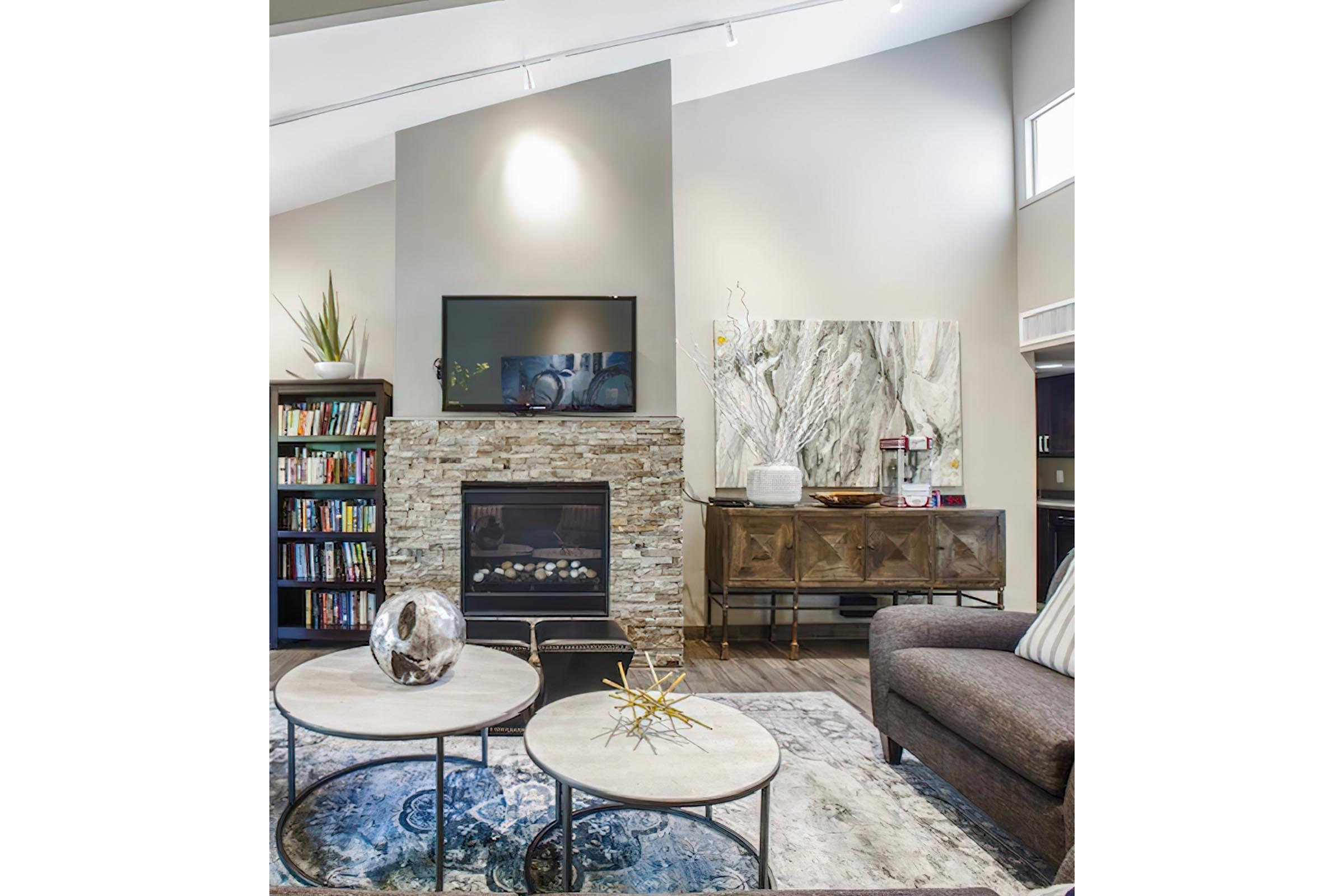 a living room filled with furniture and a fireplace