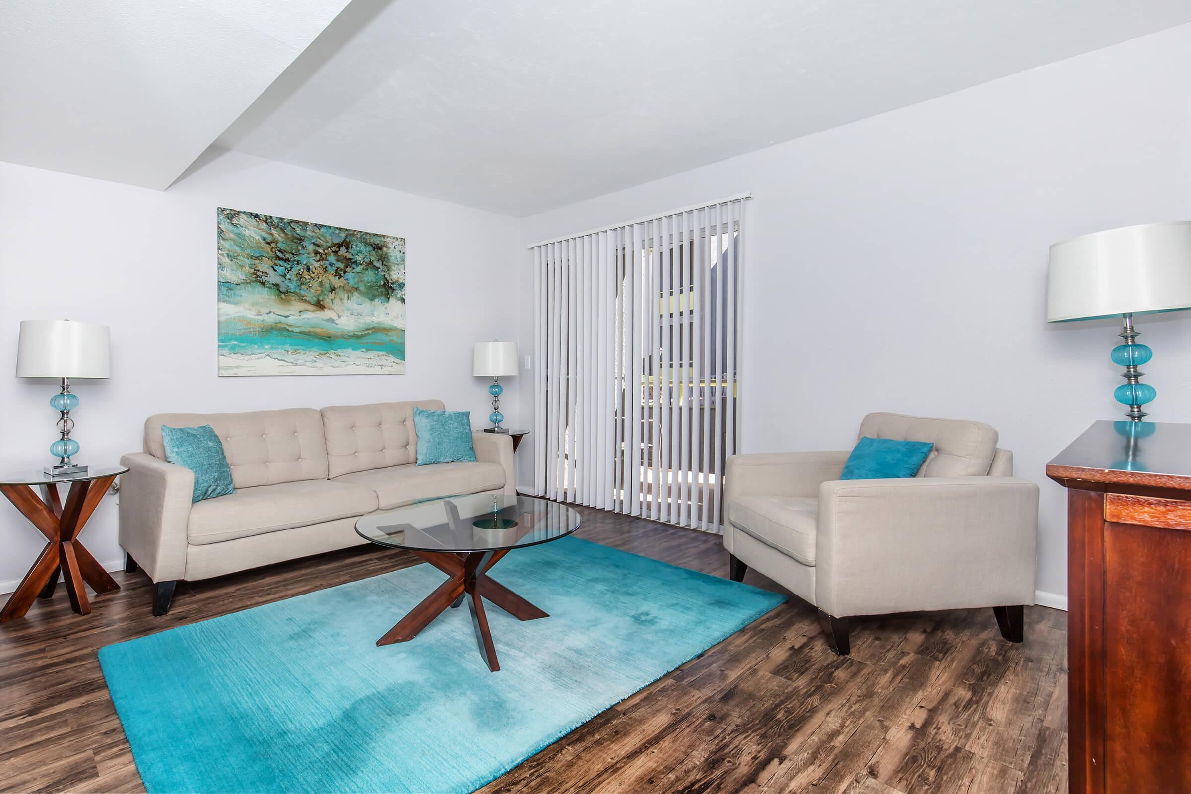 a living room filled with furniture and a flat screen tv