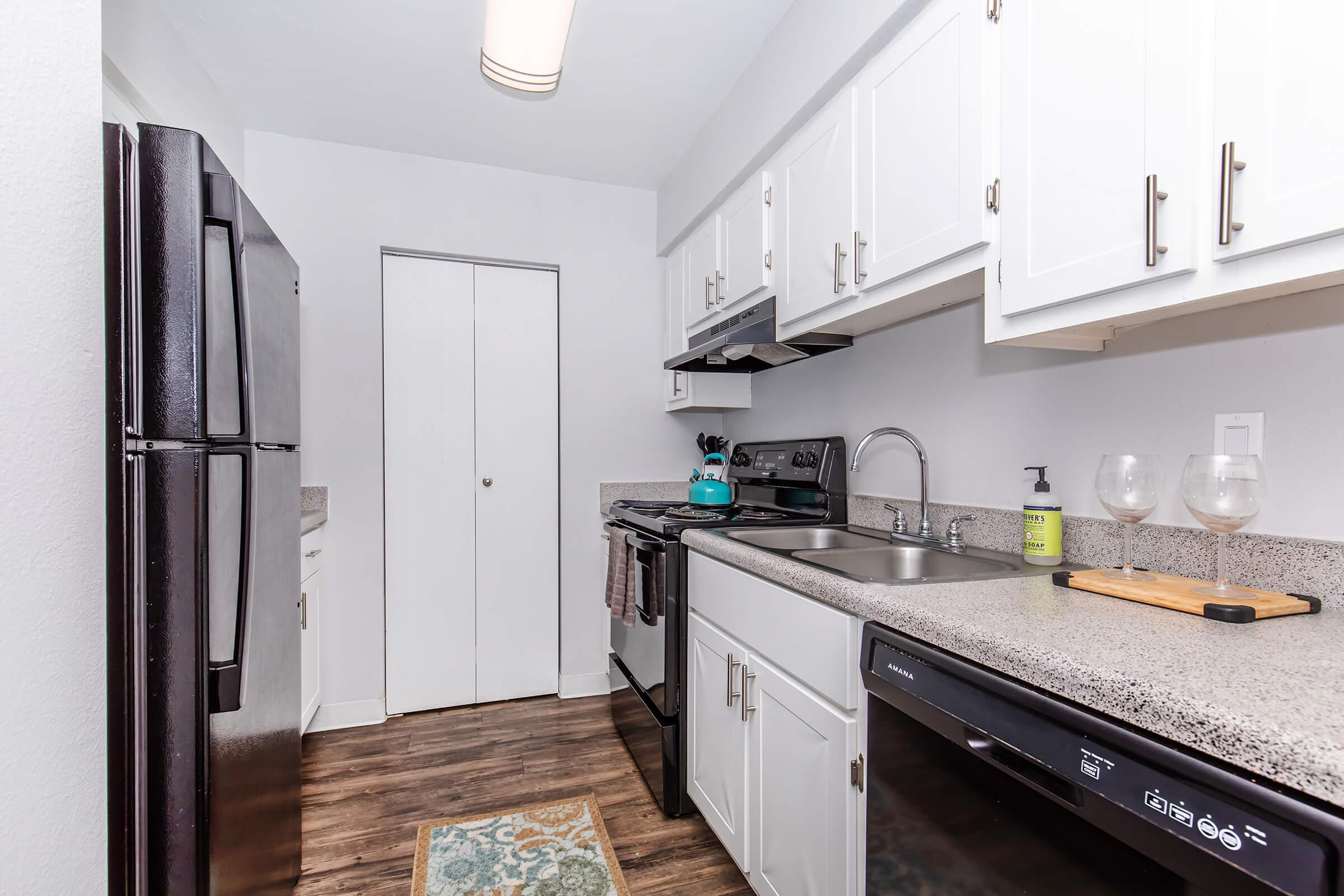 a kitchen with a sink and a refrigerator