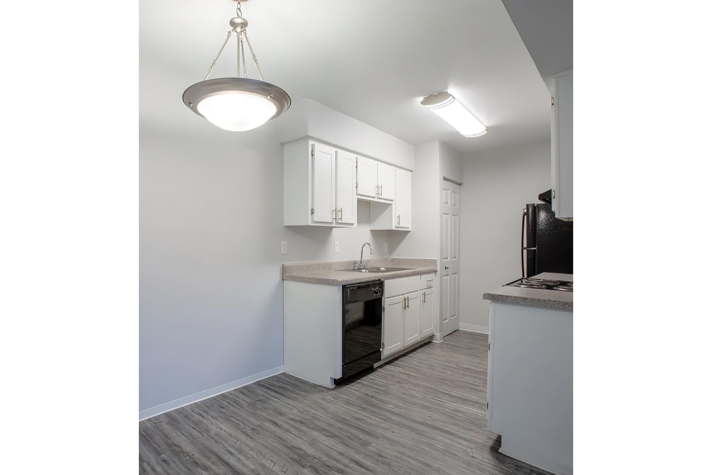 a kitchen with a sink and a refrigerator