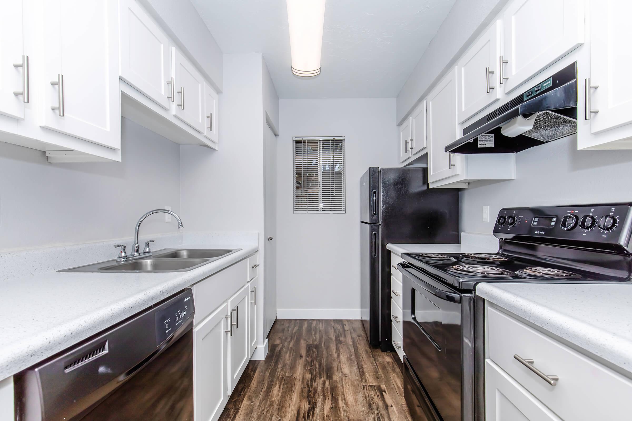 a kitchen with a stove sink and refrigerator