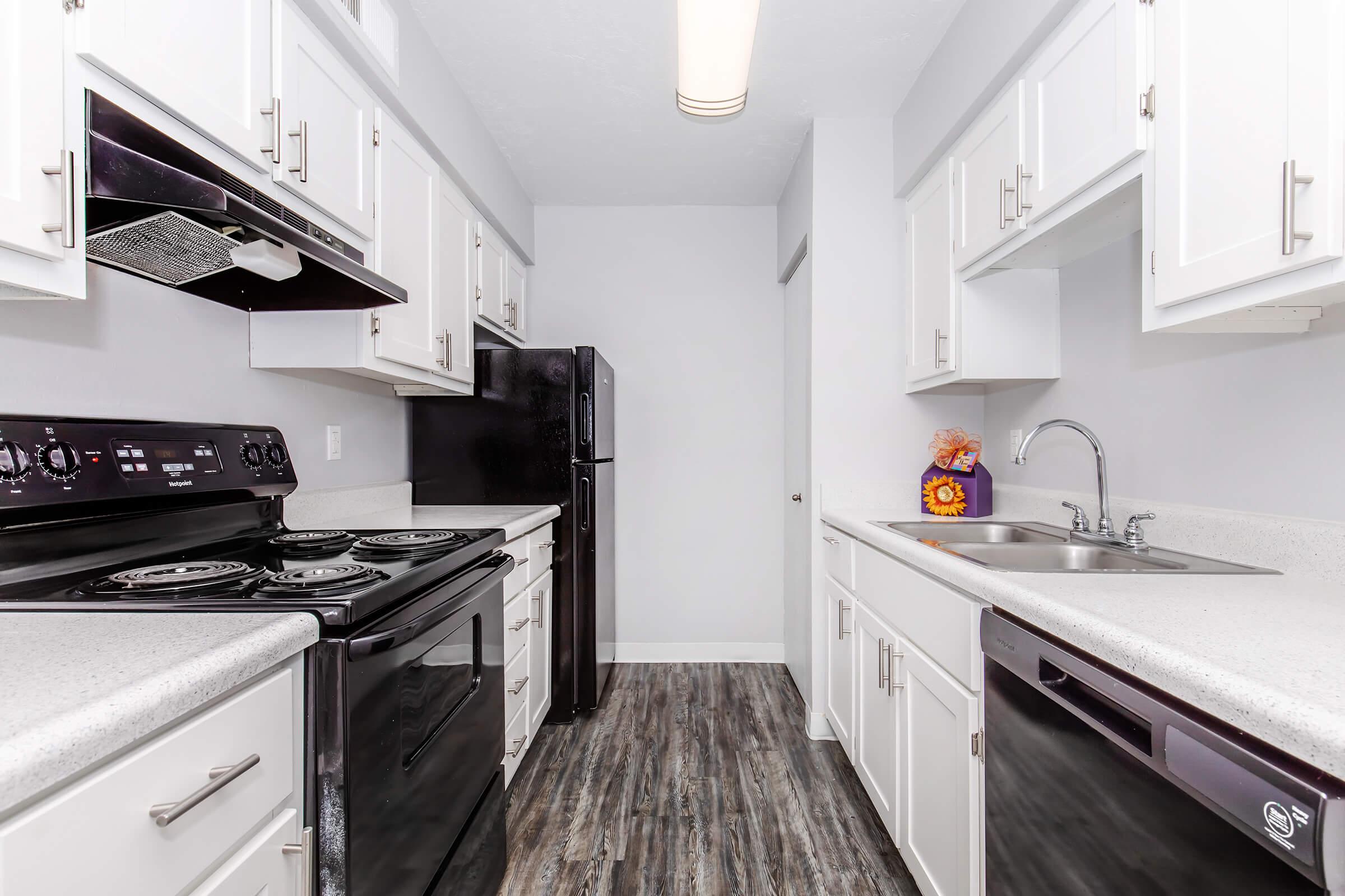 a kitchen with a stove sink and refrigerator