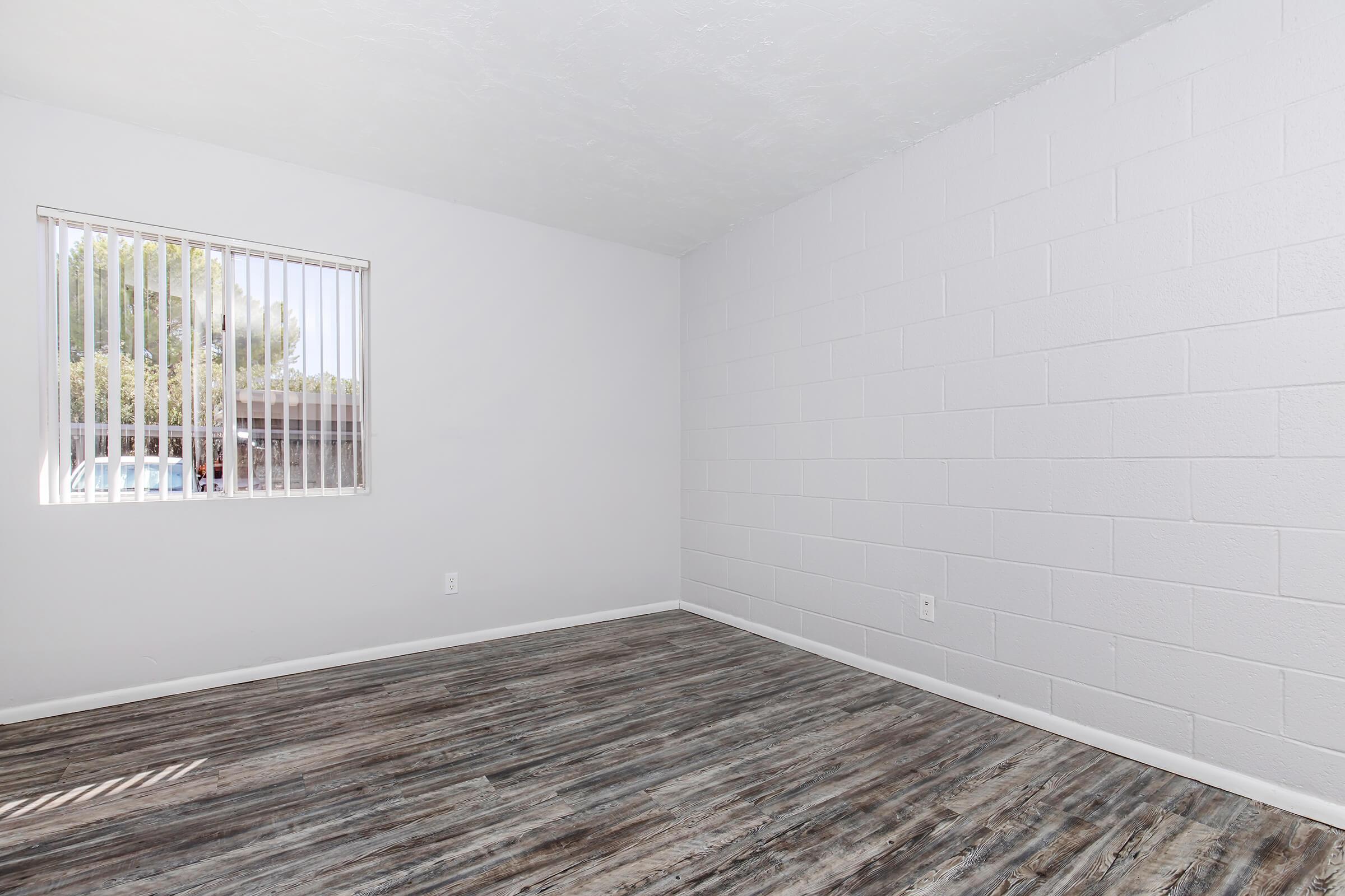 a bedroom with a building in the background