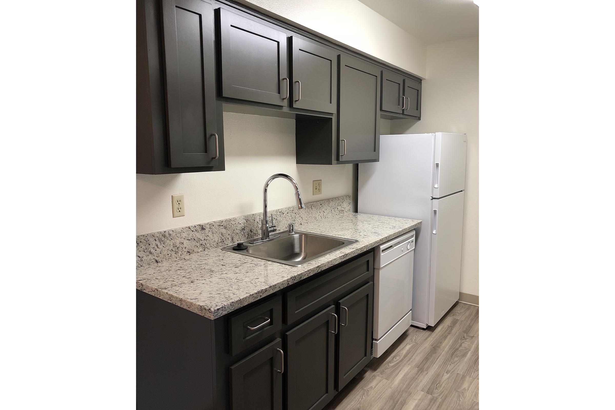 a kitchen with a sink and a mirror