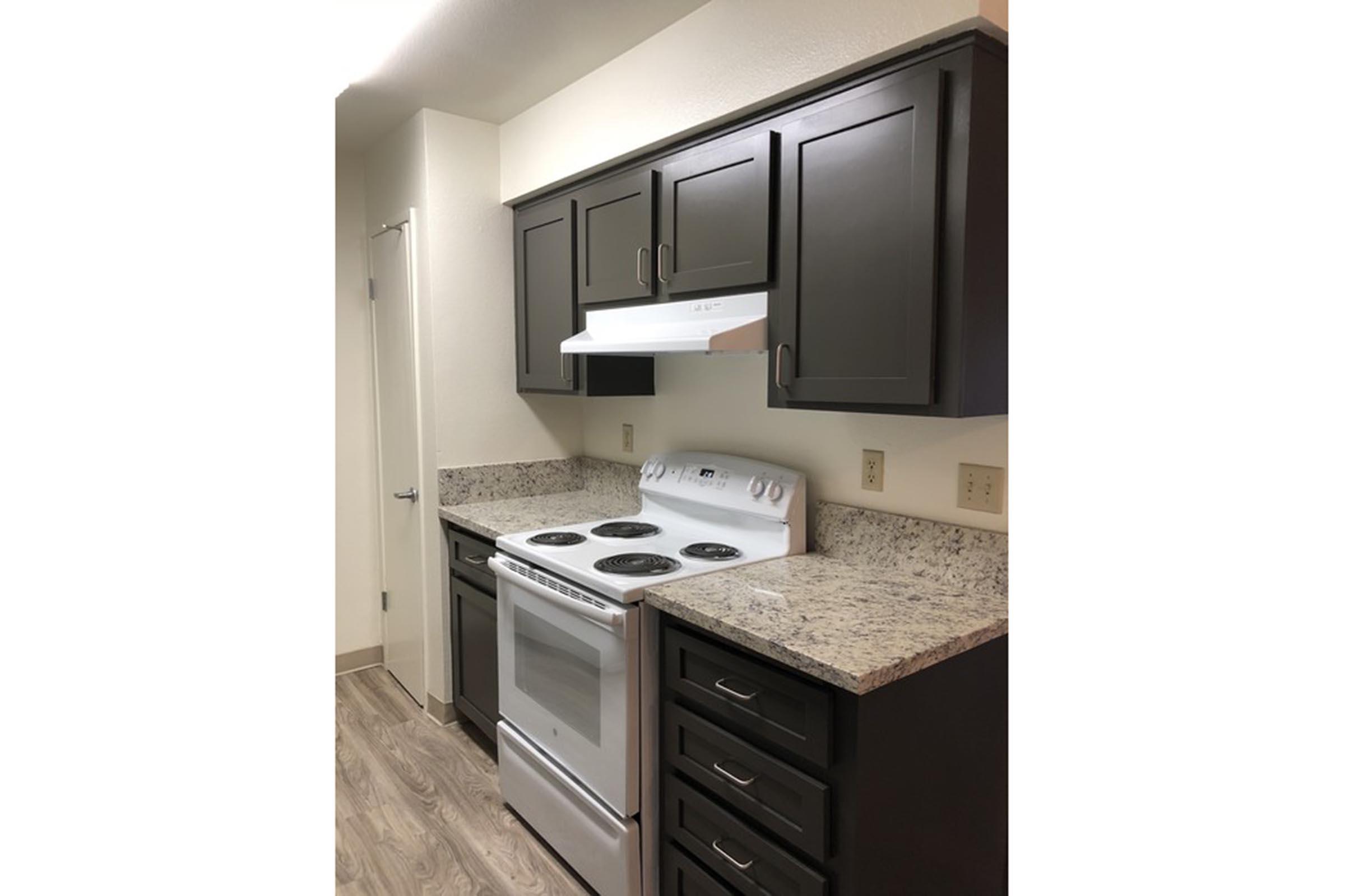 a stove top oven sitting inside of a kitchen