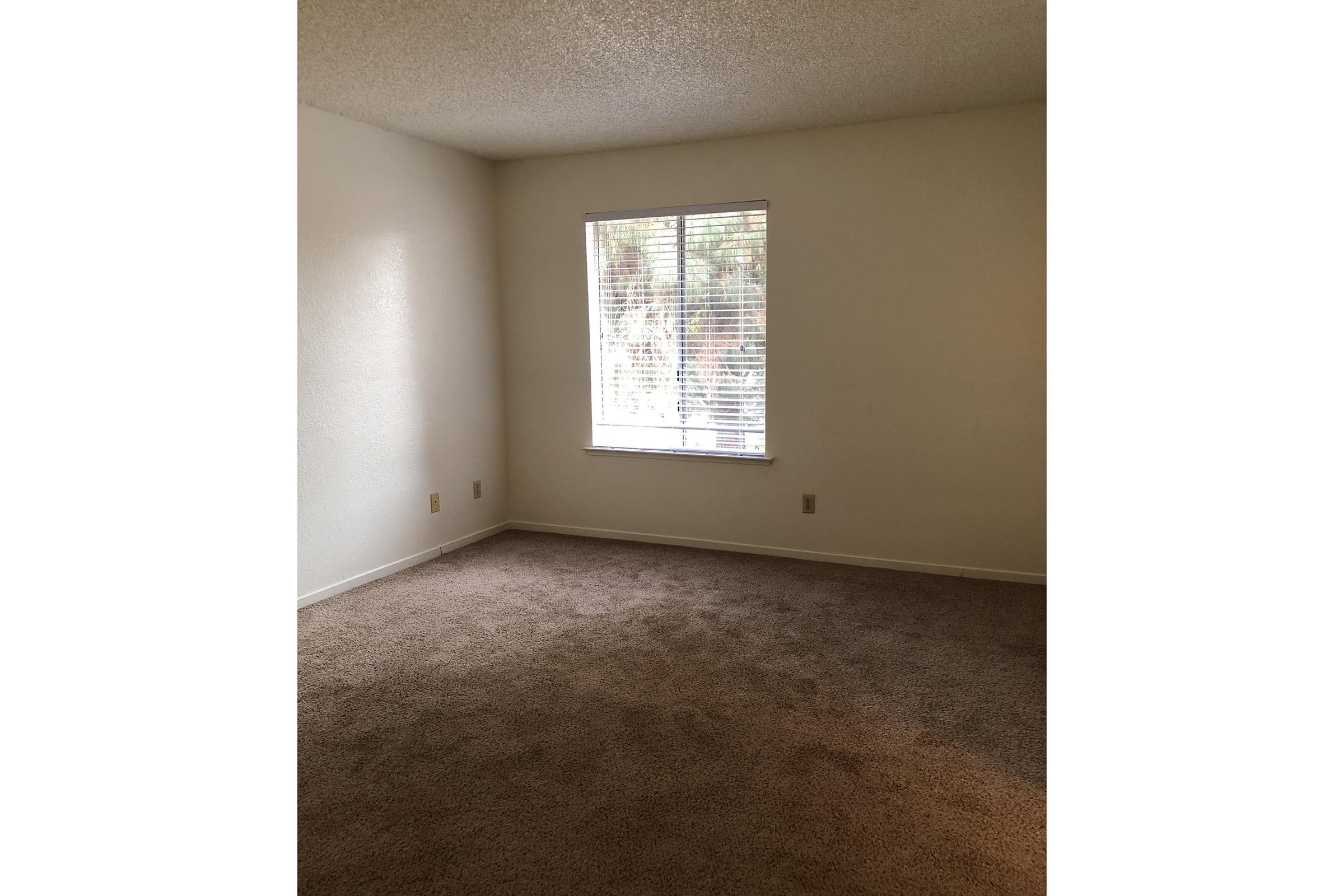 a view of a bedroom next to a window