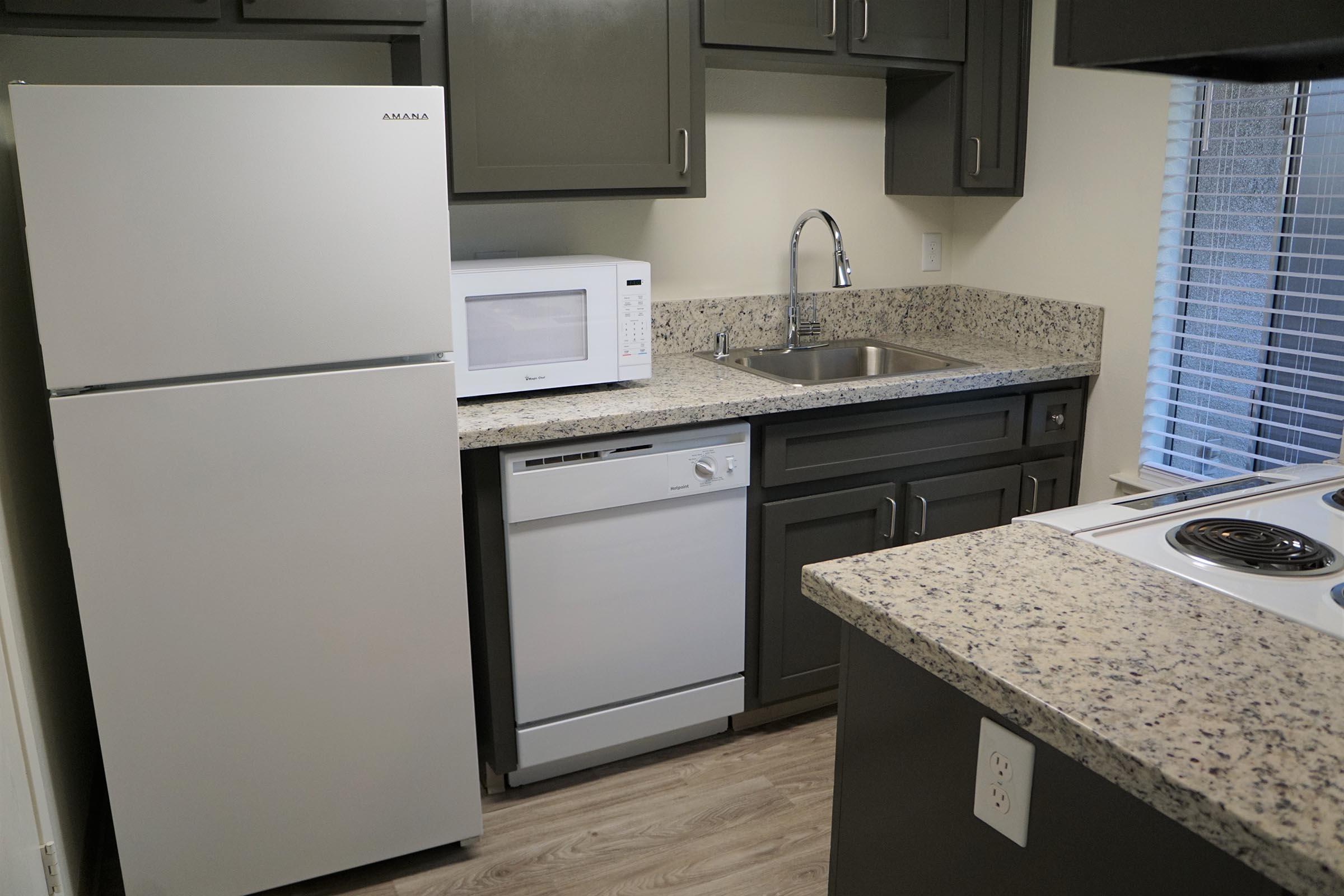 a kitchen with a stove sink and refrigerator