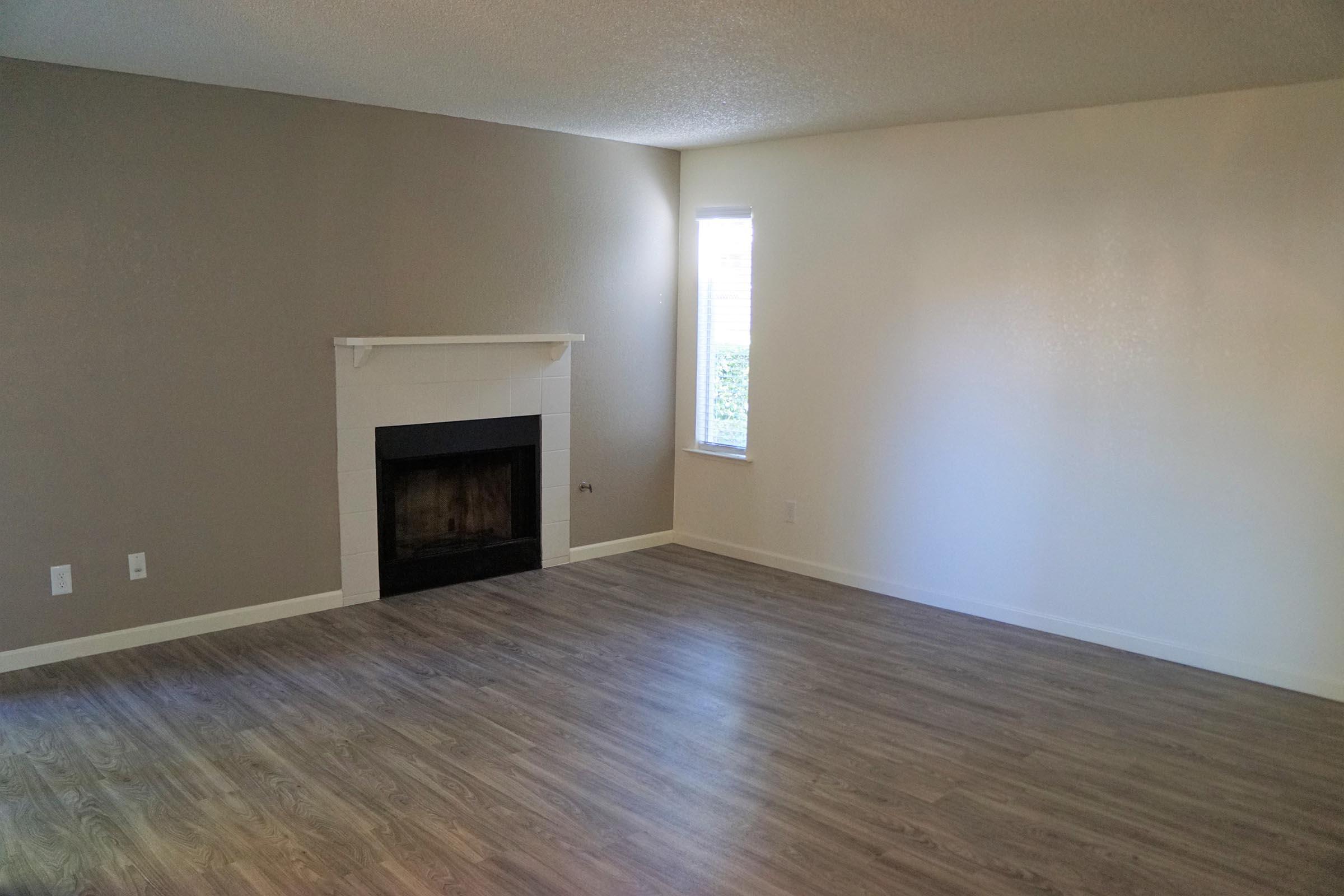 a large empty room with a wood floor