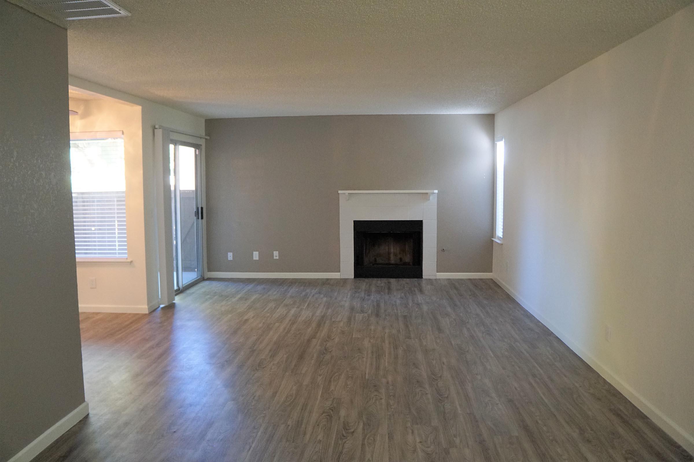 a large empty room with a wood floor