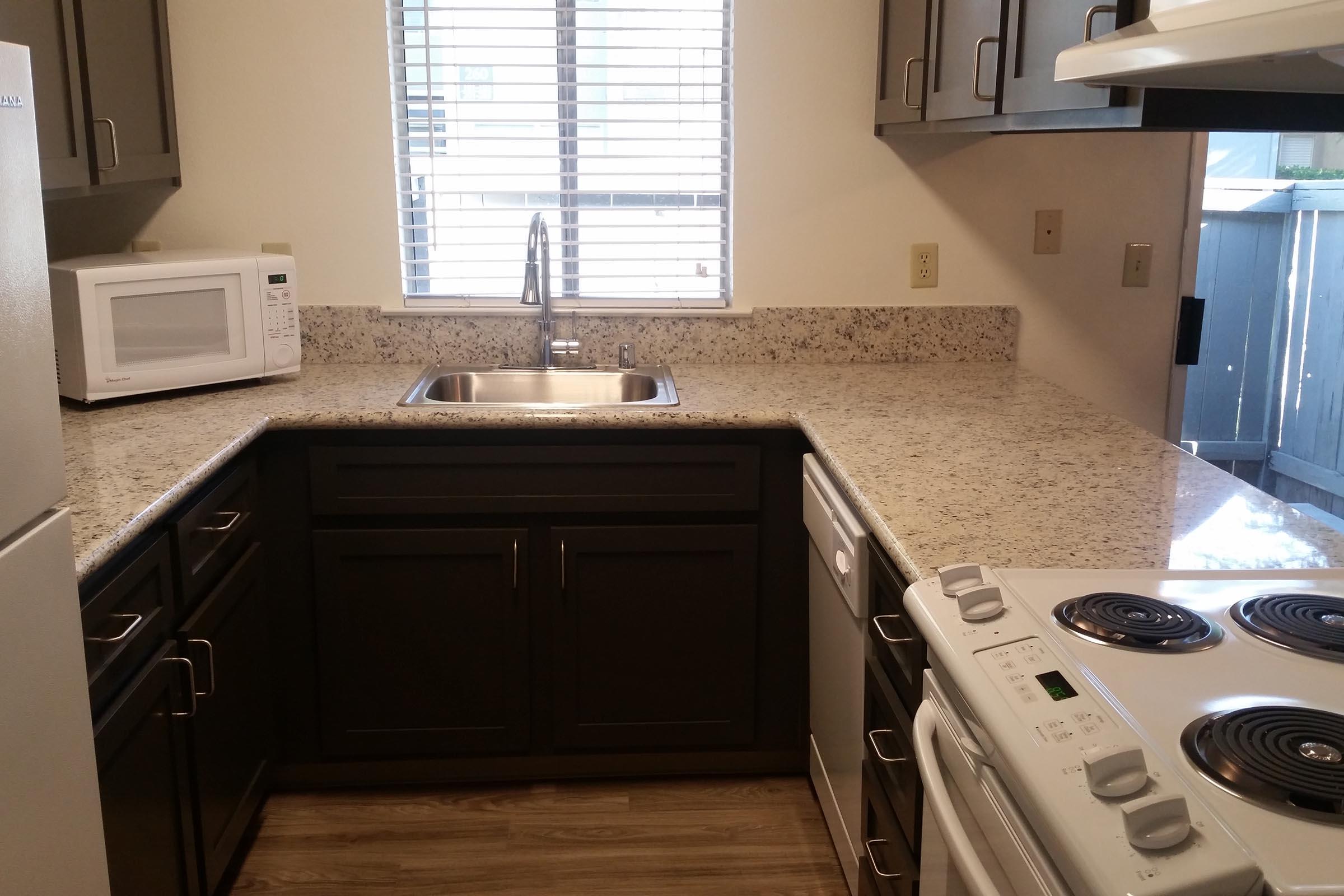 a stove top oven sitting inside of a kitchen