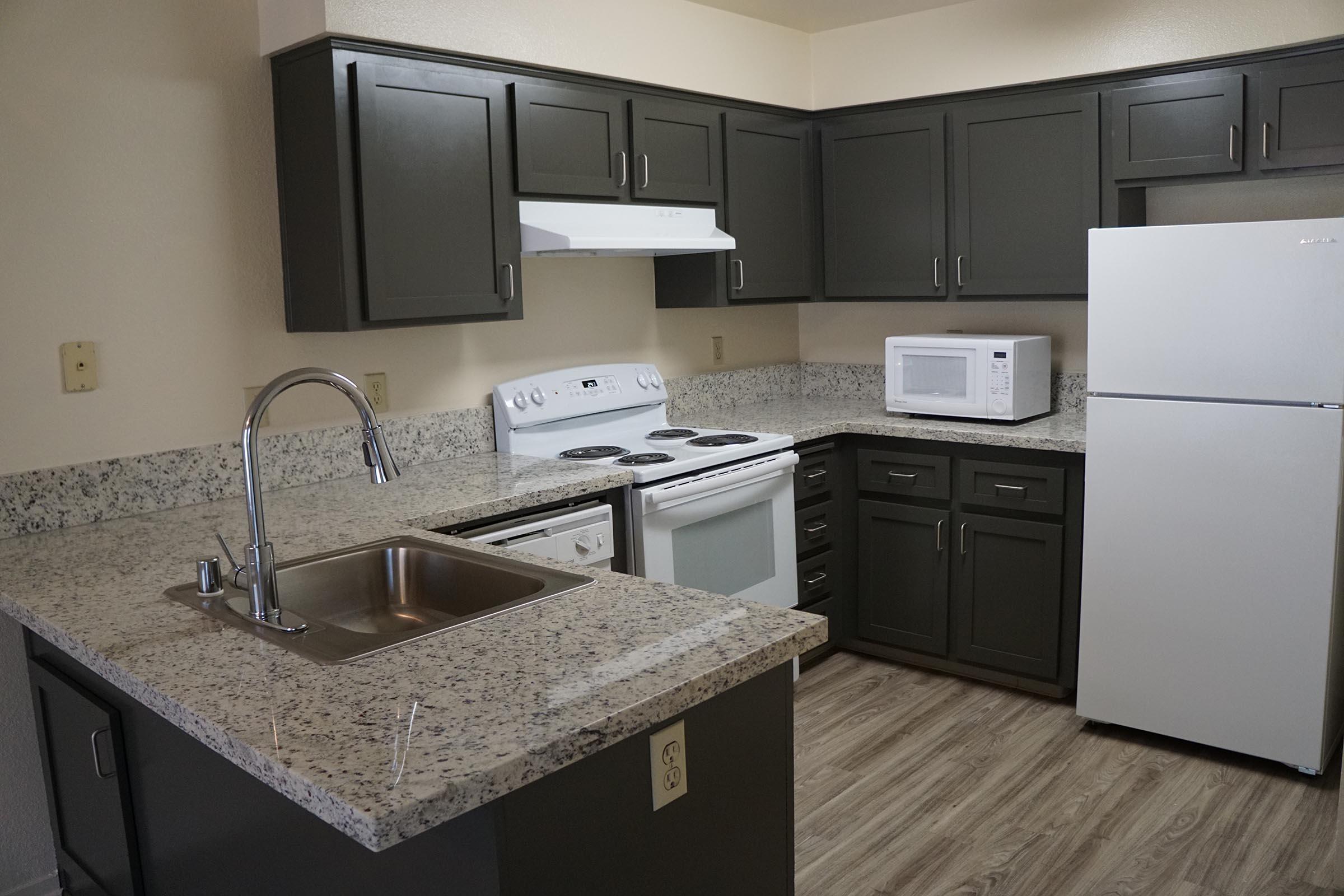 a kitchen with a sink and a refrigerator