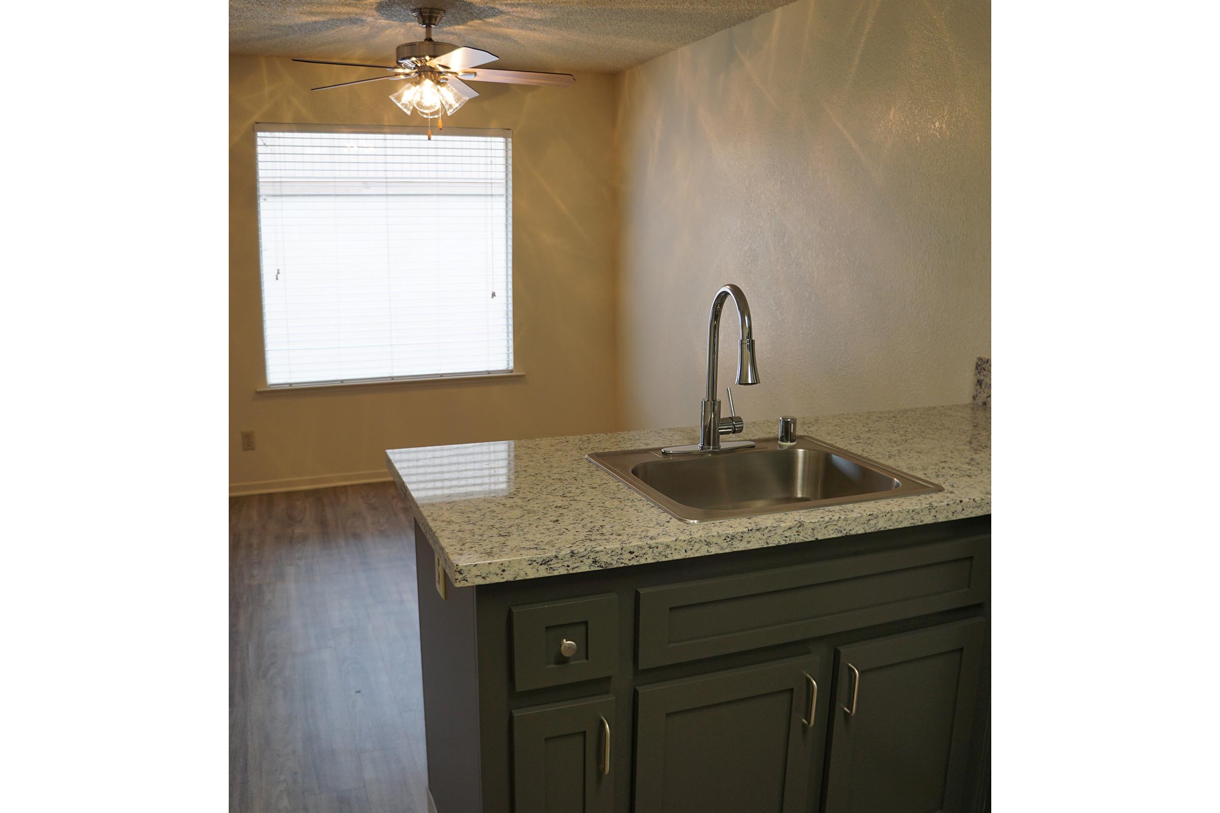 a kitchen with a sink and a mirror