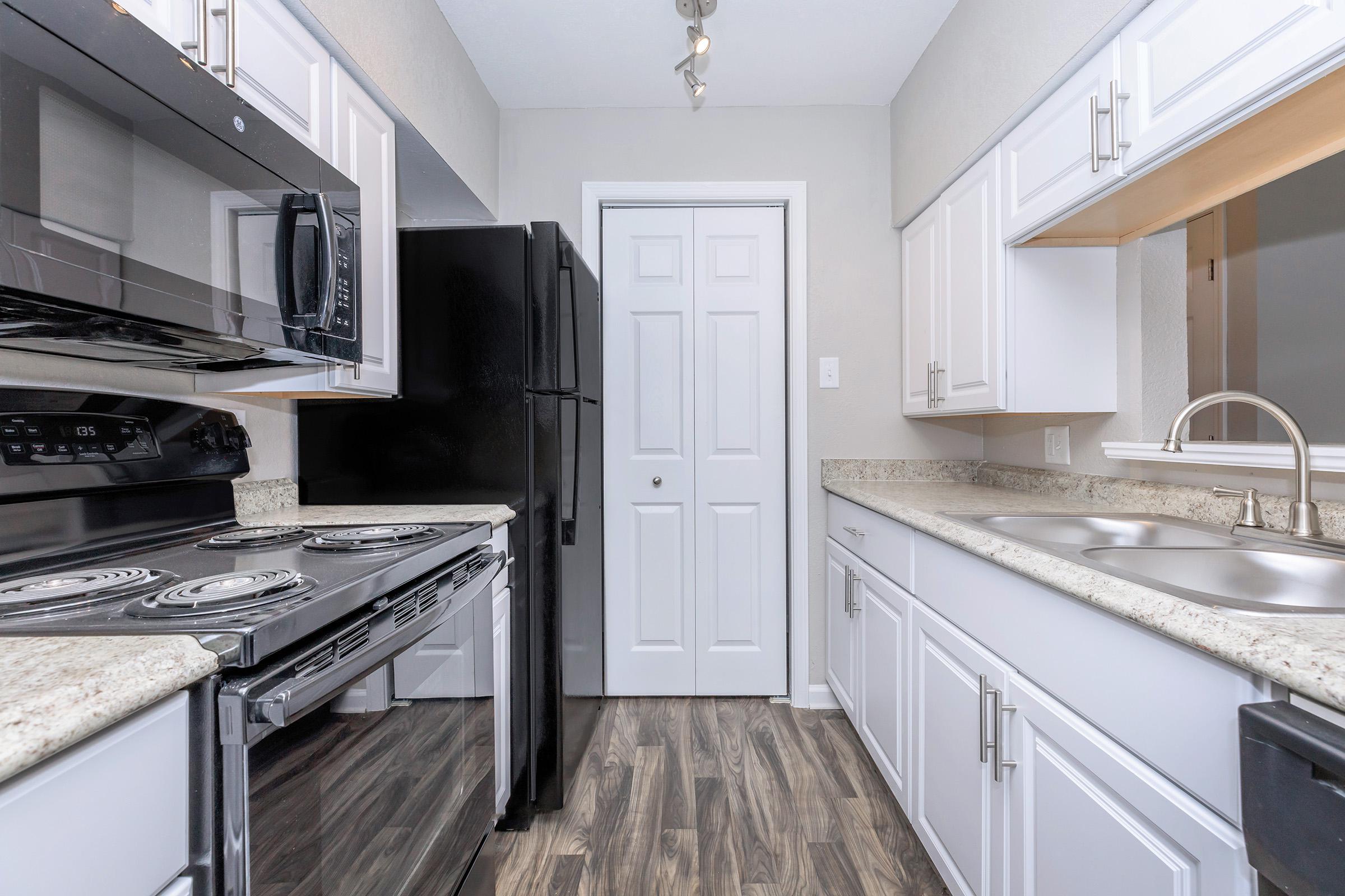 a large kitchen with stainless steel appliances