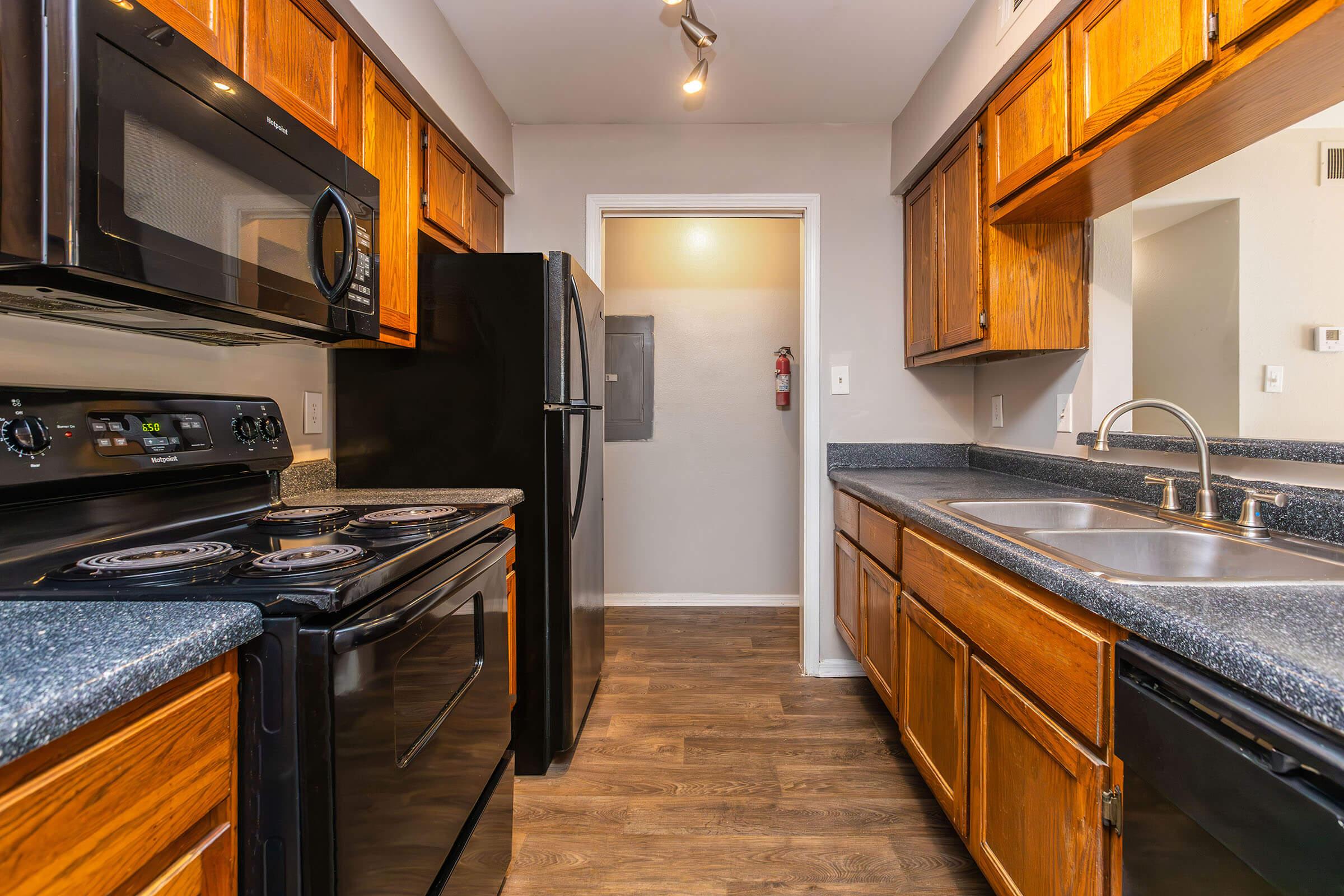 a modern kitchen with stainless steel appliances and wooden cabinets