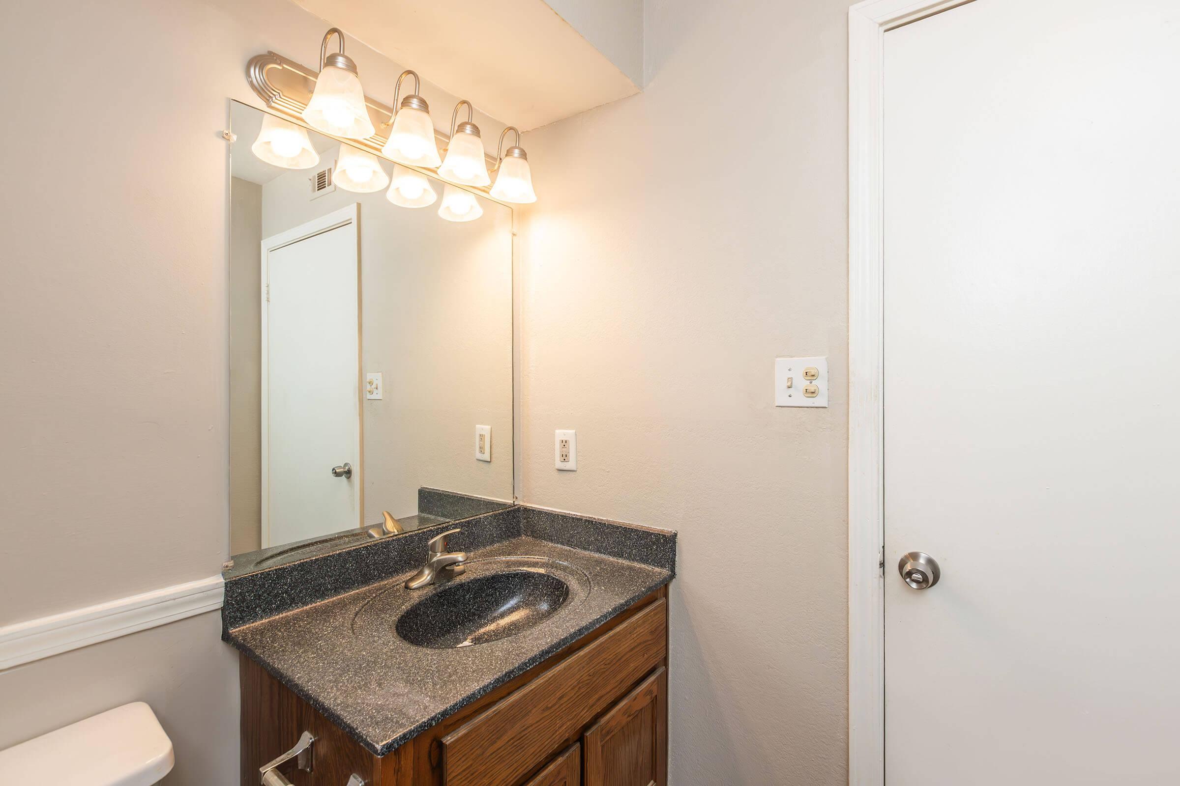 a kitchen with a sink and a mirror