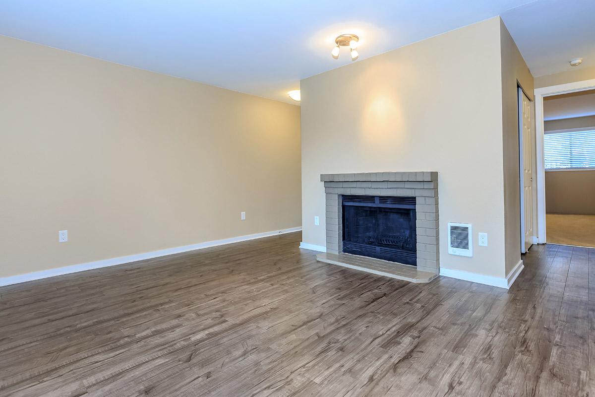 a large empty room with a wood floor