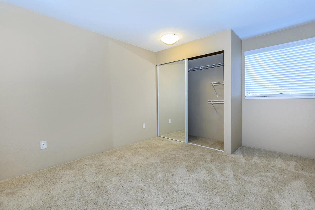 a bedroom with a bed and a mirror