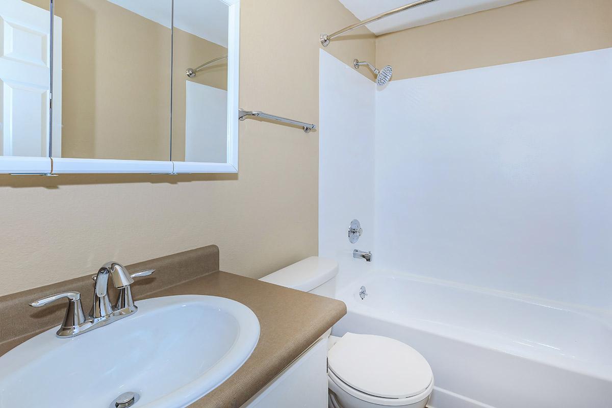 a large white tub sitting next to a sink