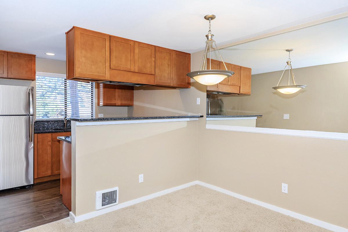 a kitchen with wooden cabinets
