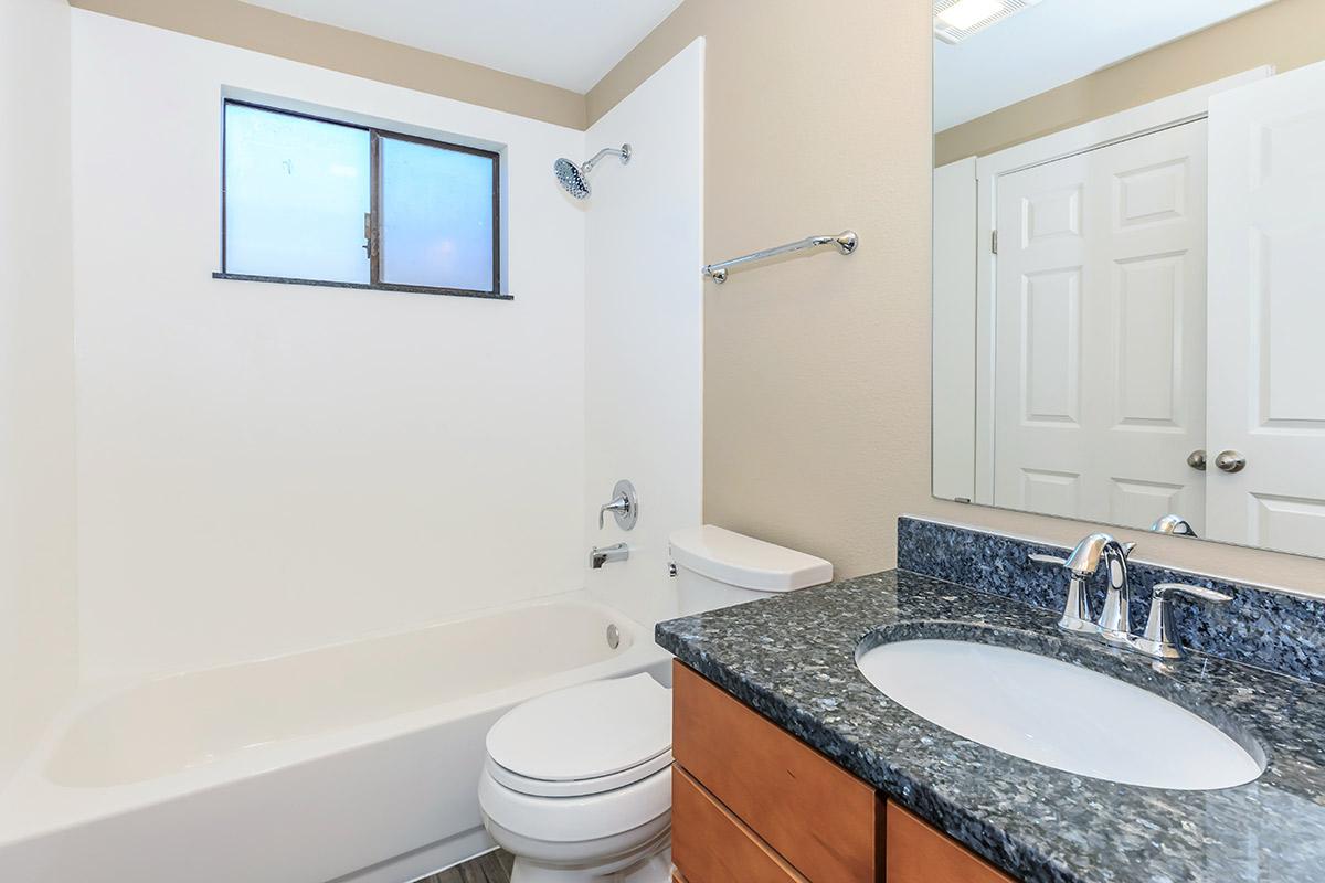 a white sink and a mirror