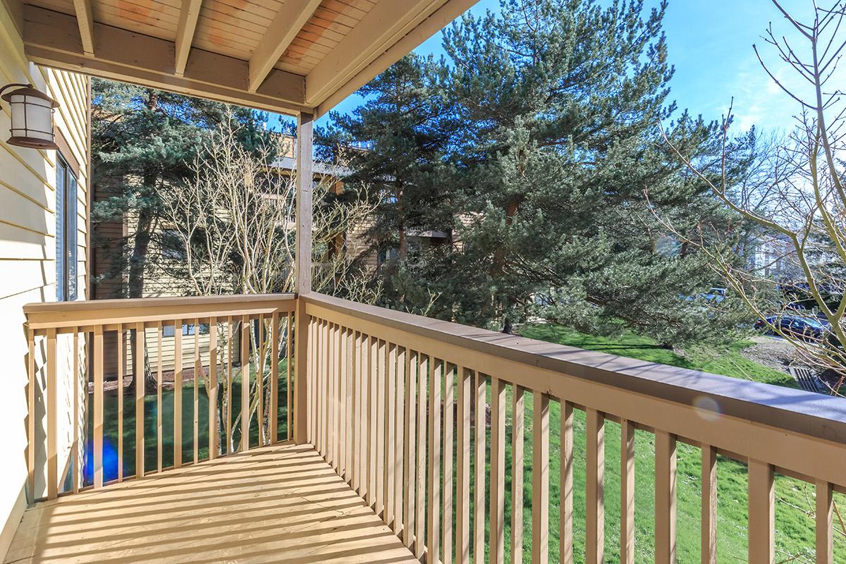 a wooden bench sitting next to a fence