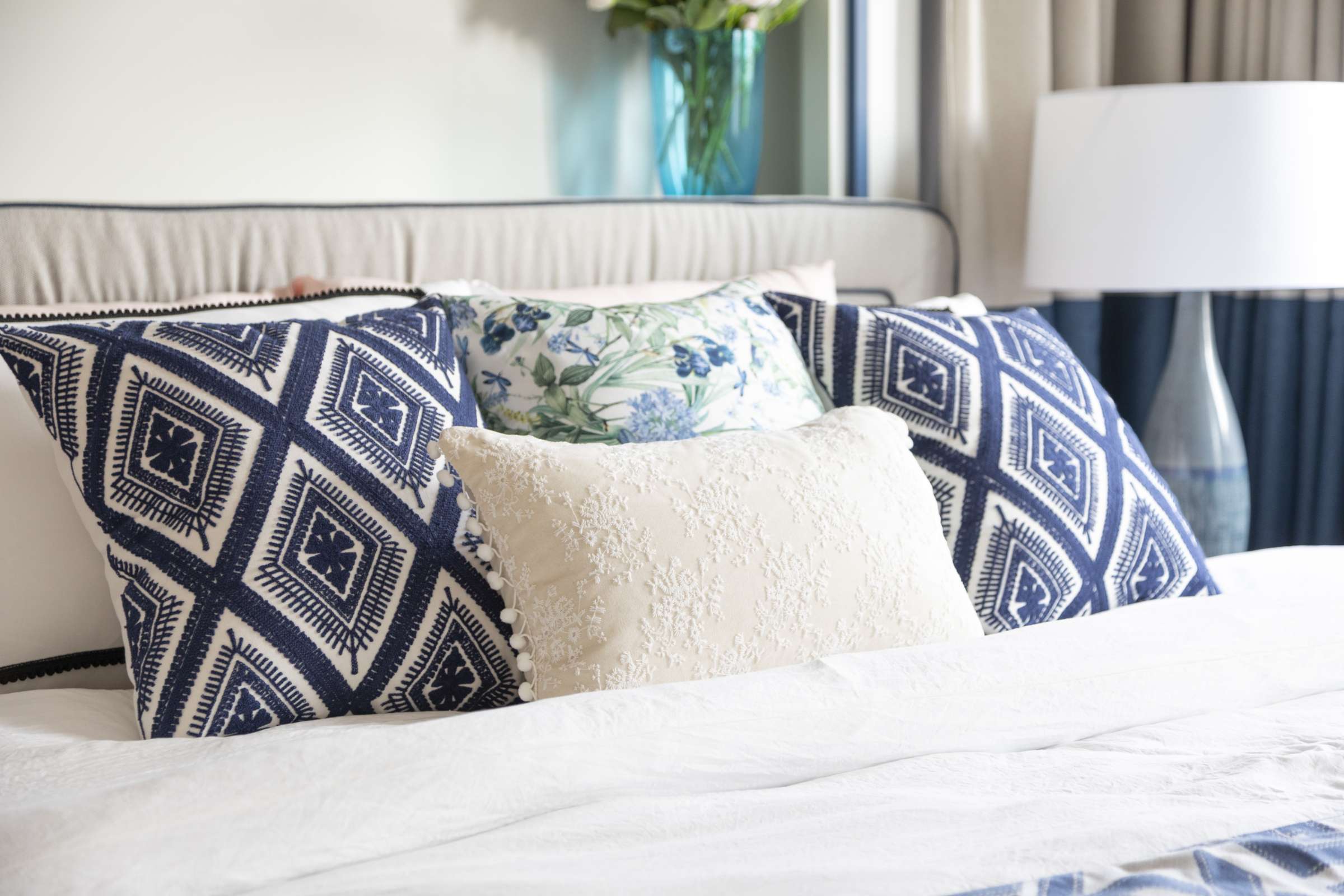 bed with pillows and lamp