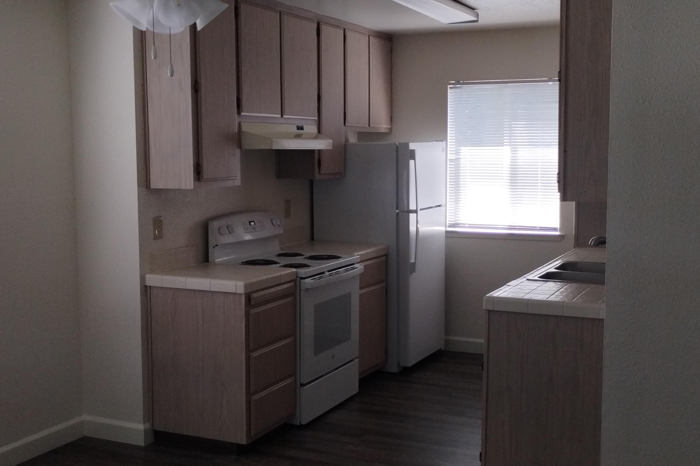 a kitchen with a sink and a mirror