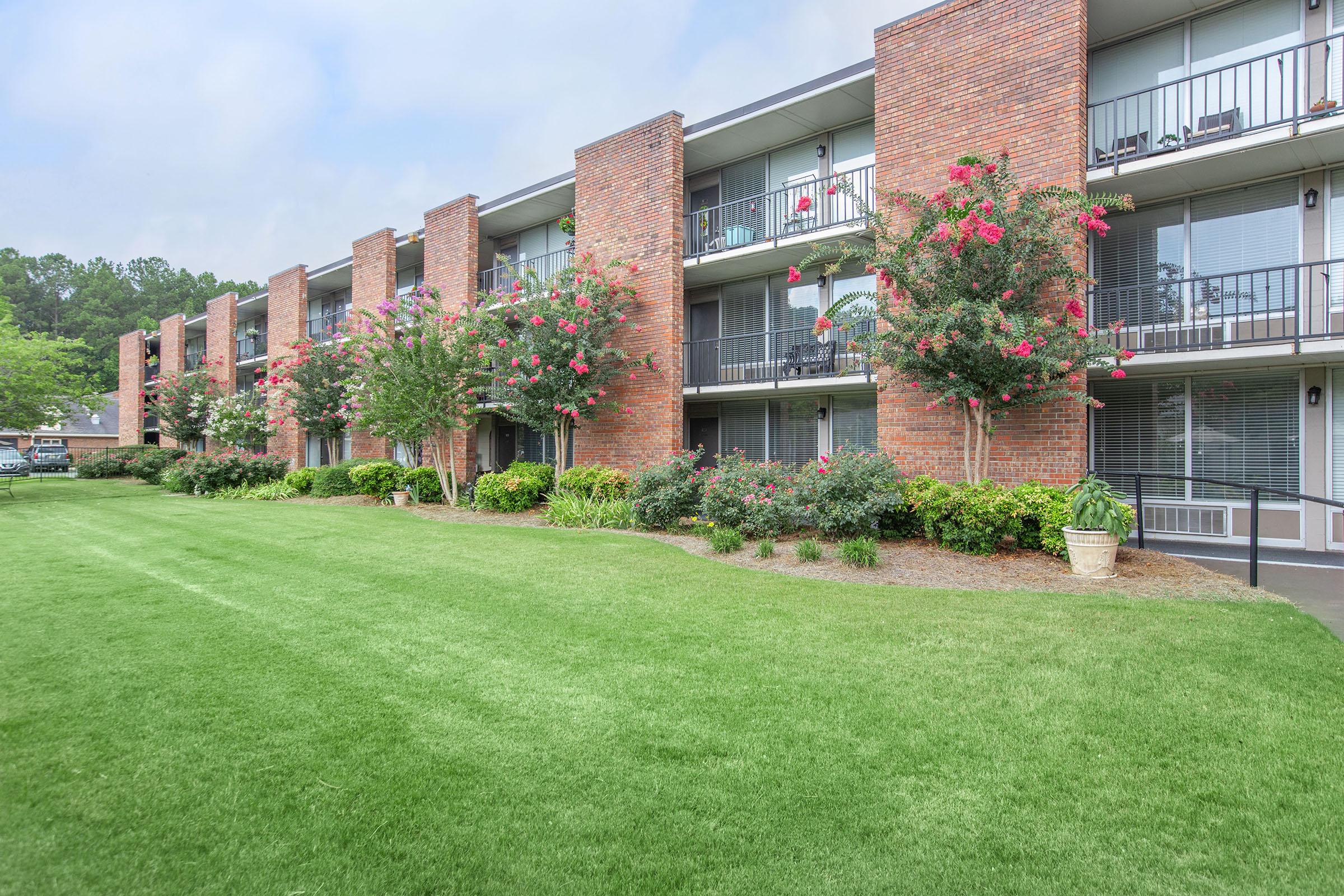 a large green field in front of a building