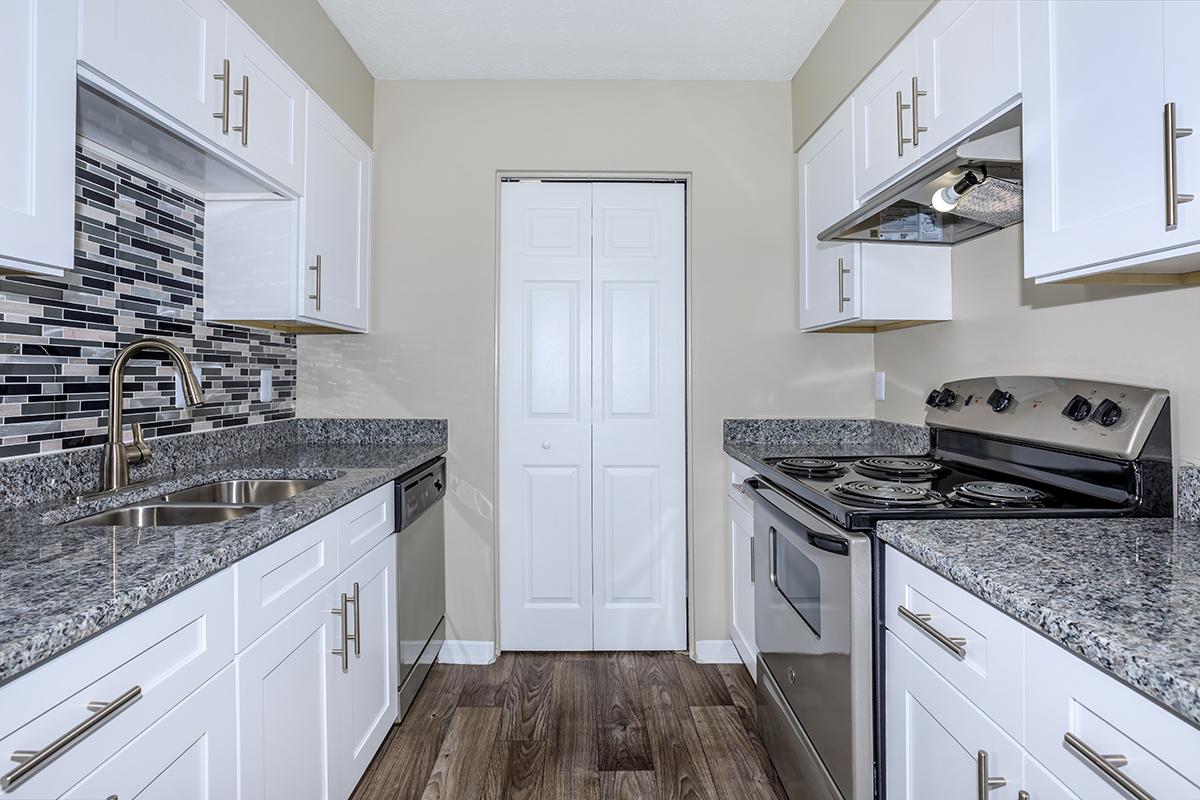 a kitchen with a stove and a sink