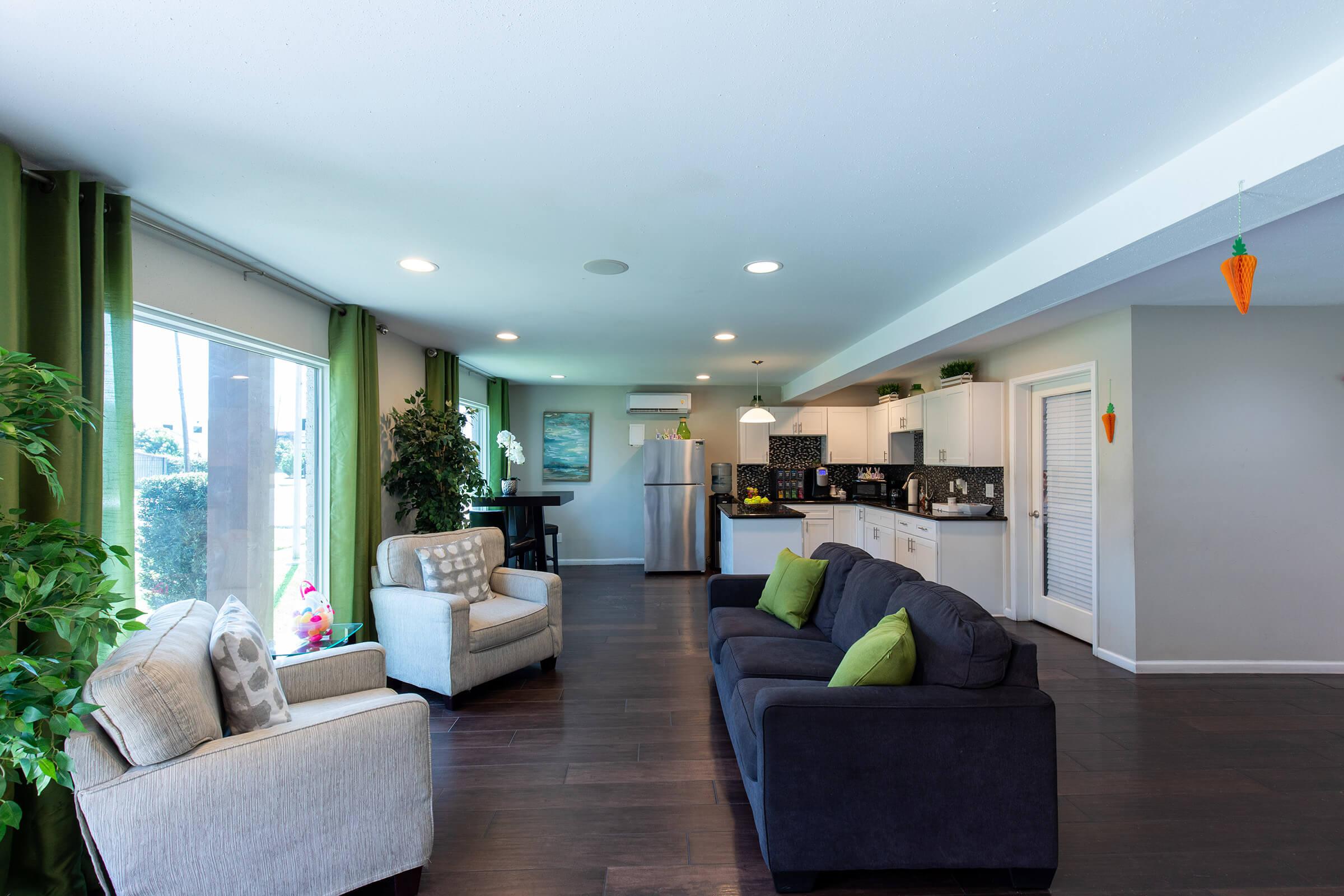 a living room filled with furniture and a large window