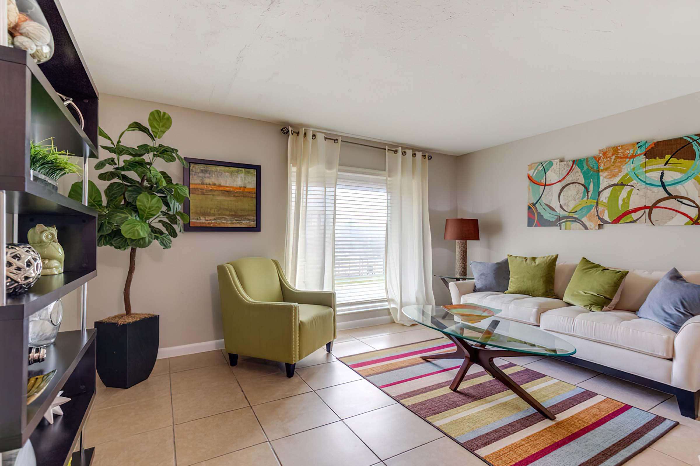 a living room filled with furniture and a large window