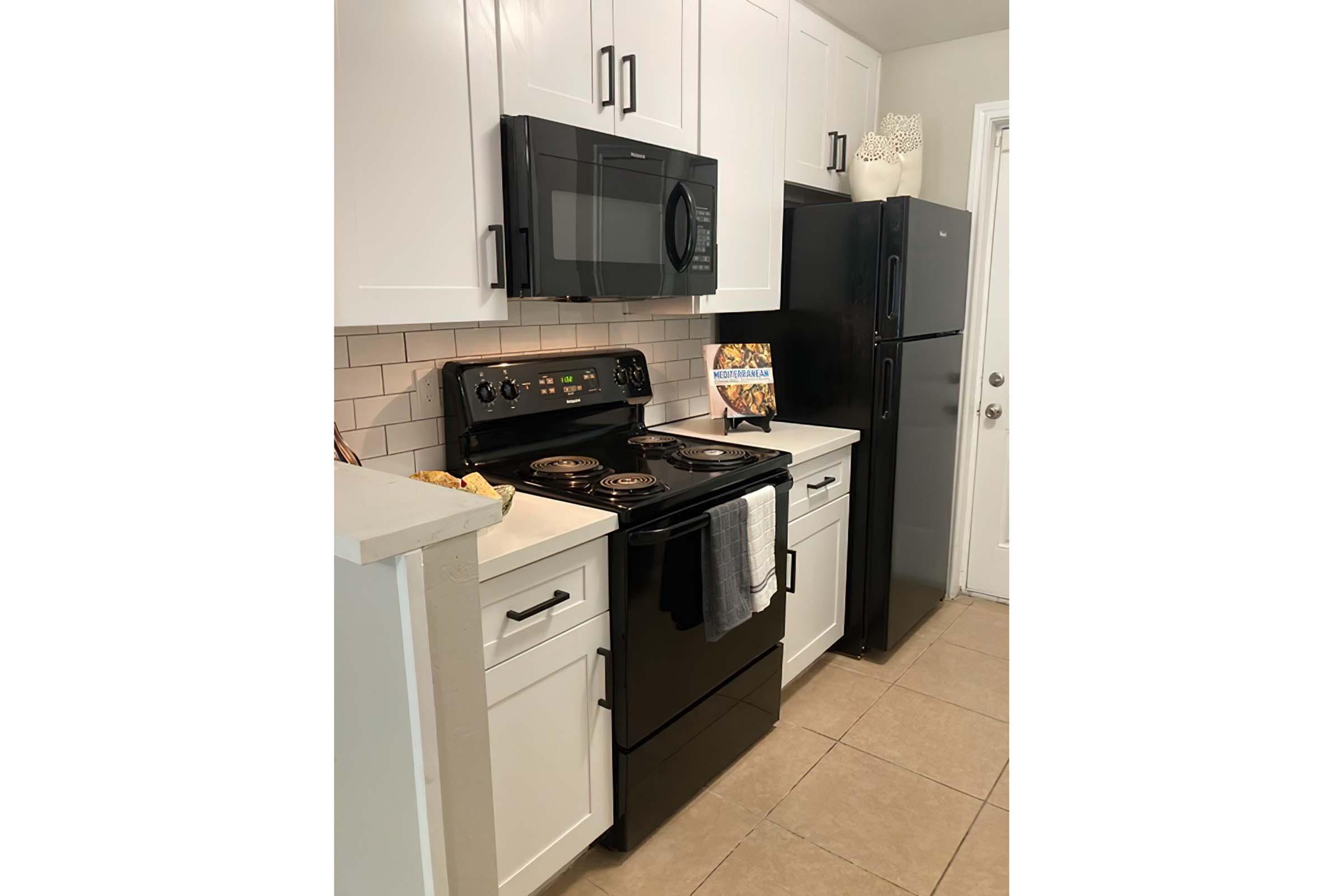 a stove top oven sitting inside of a kitchen