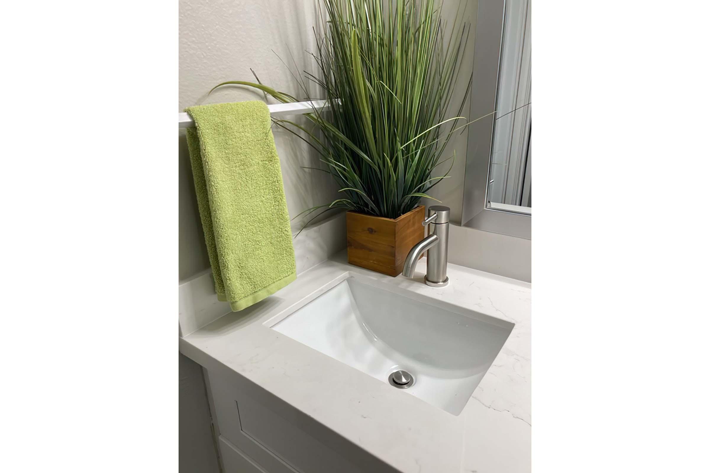 a vase of flowers next to a sink