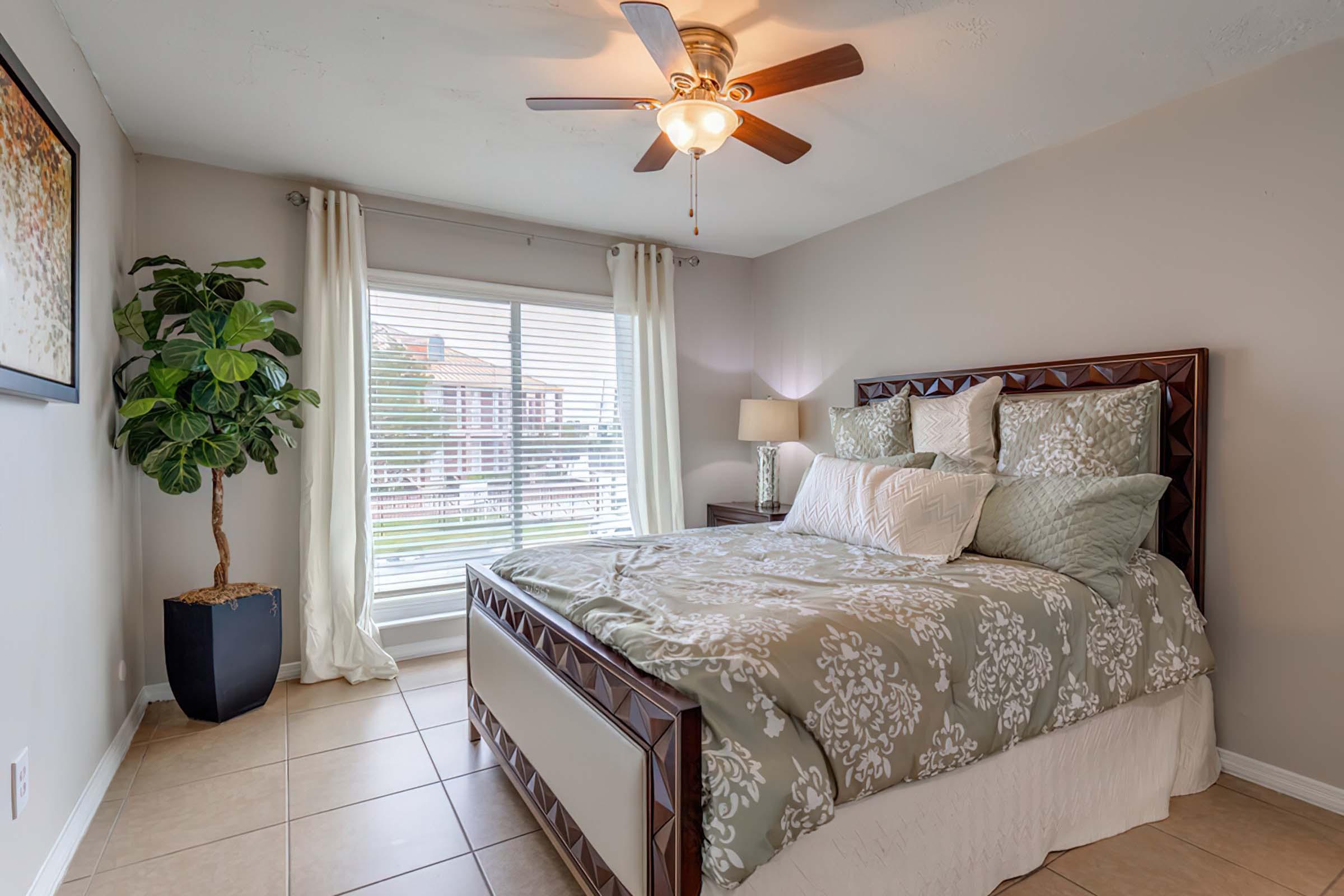 a bedroom with a bed and desk in a room