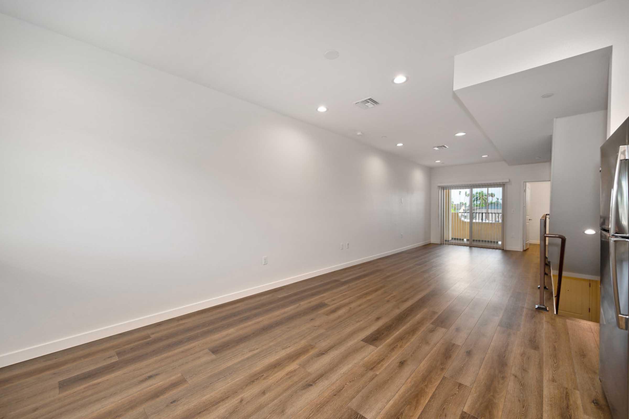 a large empty room with a wooden floor