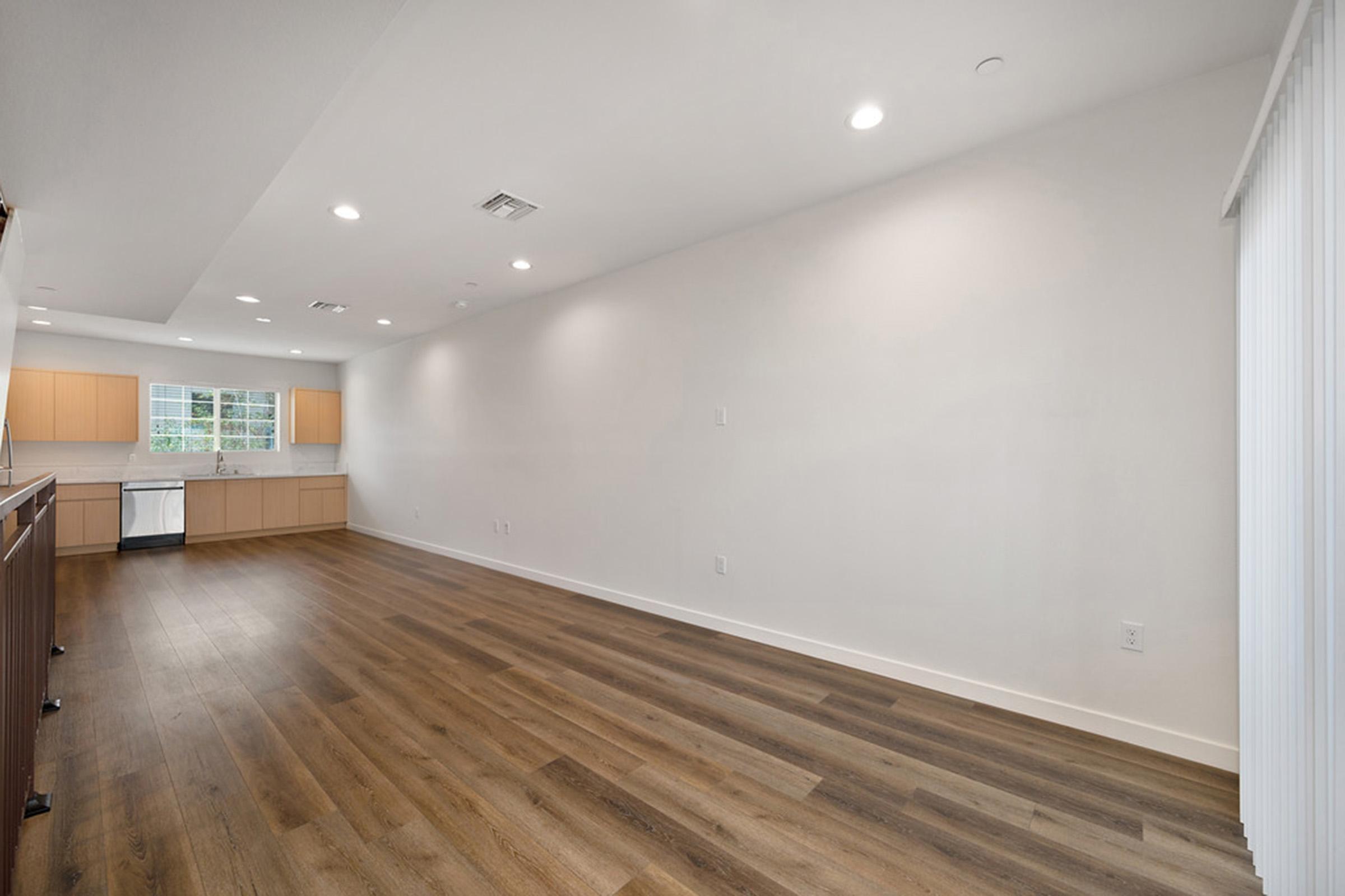 a room with a wood floor and sliding door