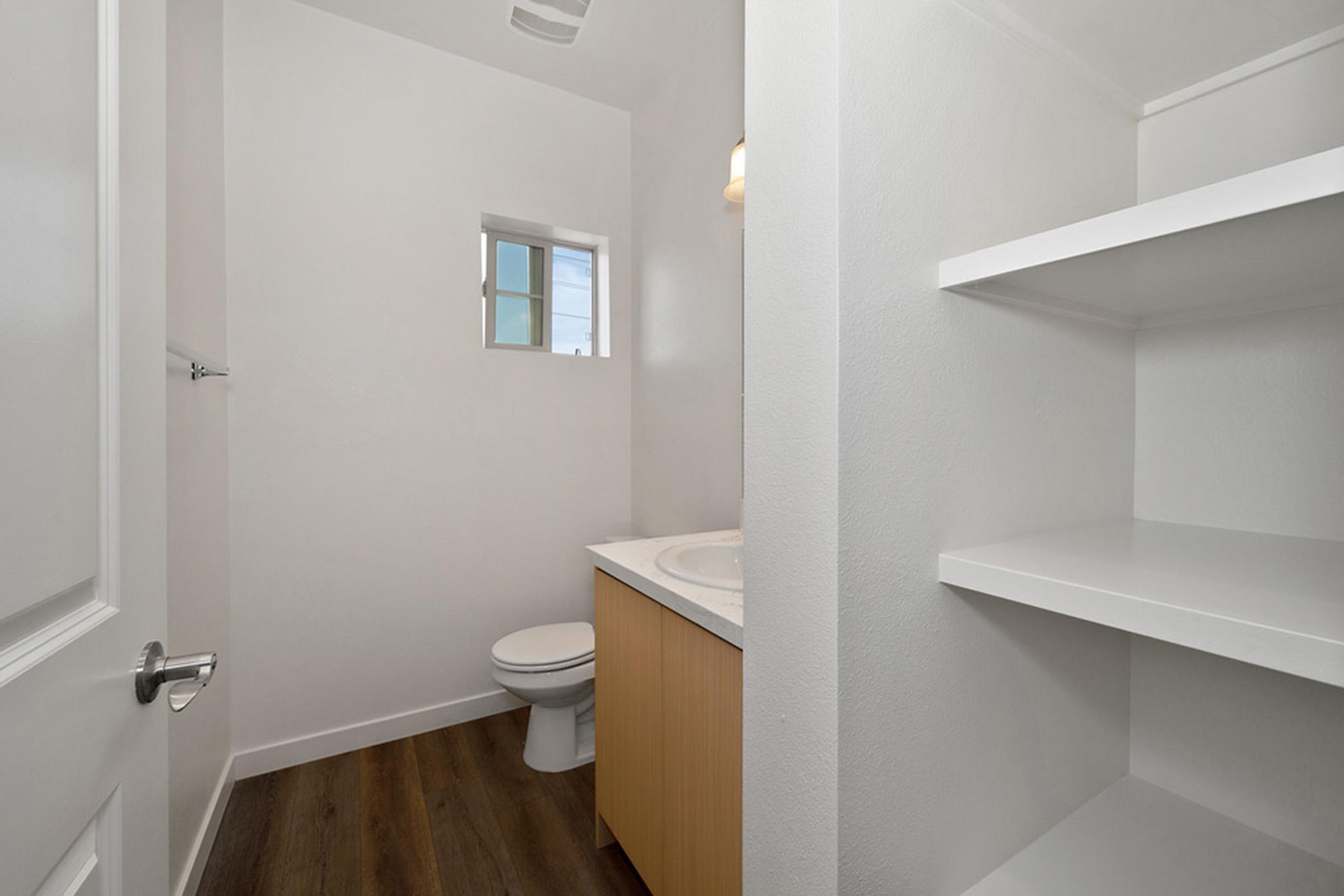 a bathroom with open shelves