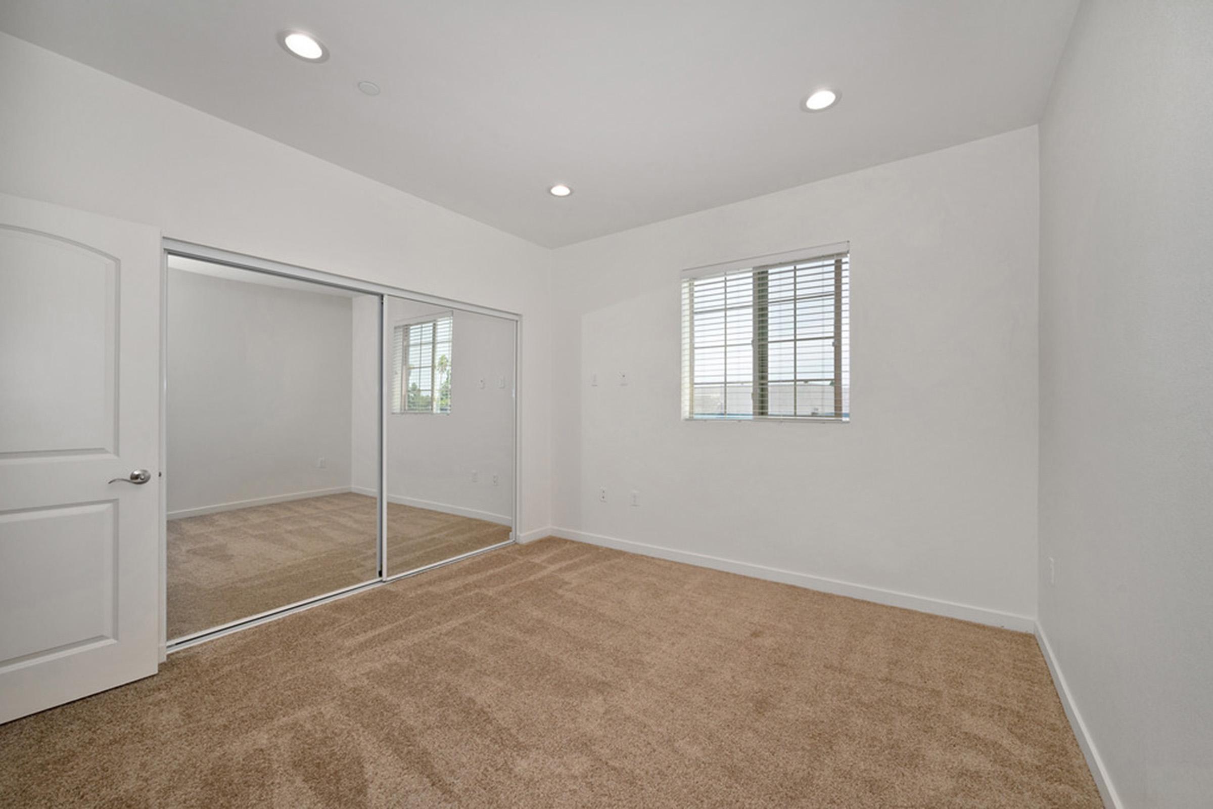 an empty bedroom with carpet