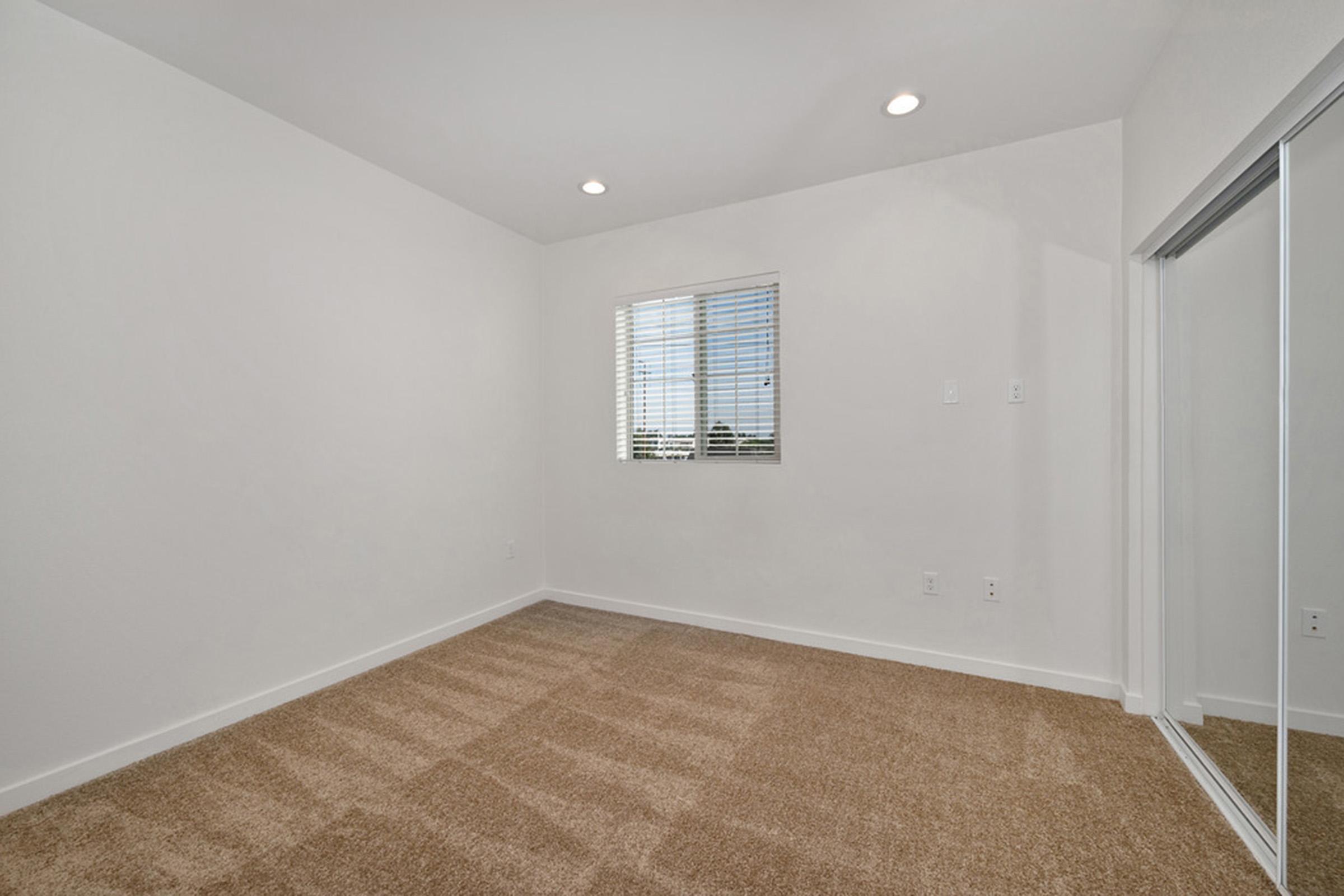 an empty bedroom with a closet