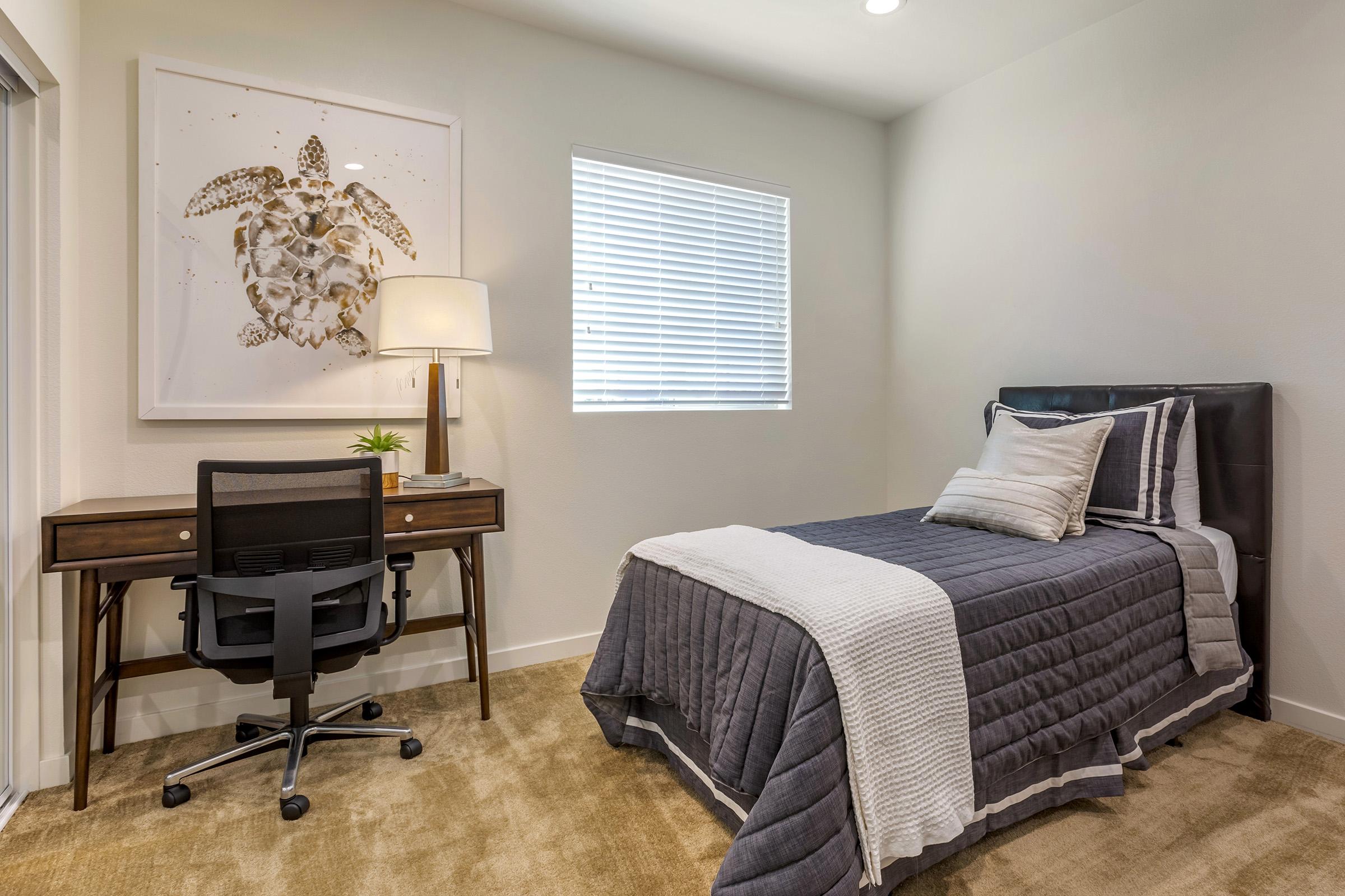 a bedroom with a bed and desk