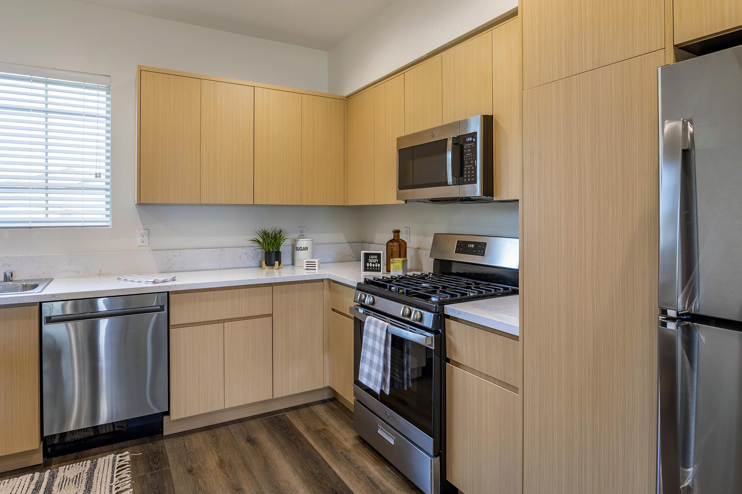 a kitchen with stainless steel appliances and wooden cabinets