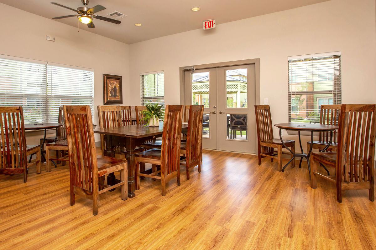 a living room filled with furniture on top of a hard wood floor