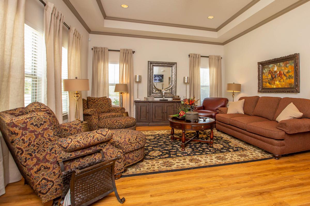 a living room filled with furniture and a large window