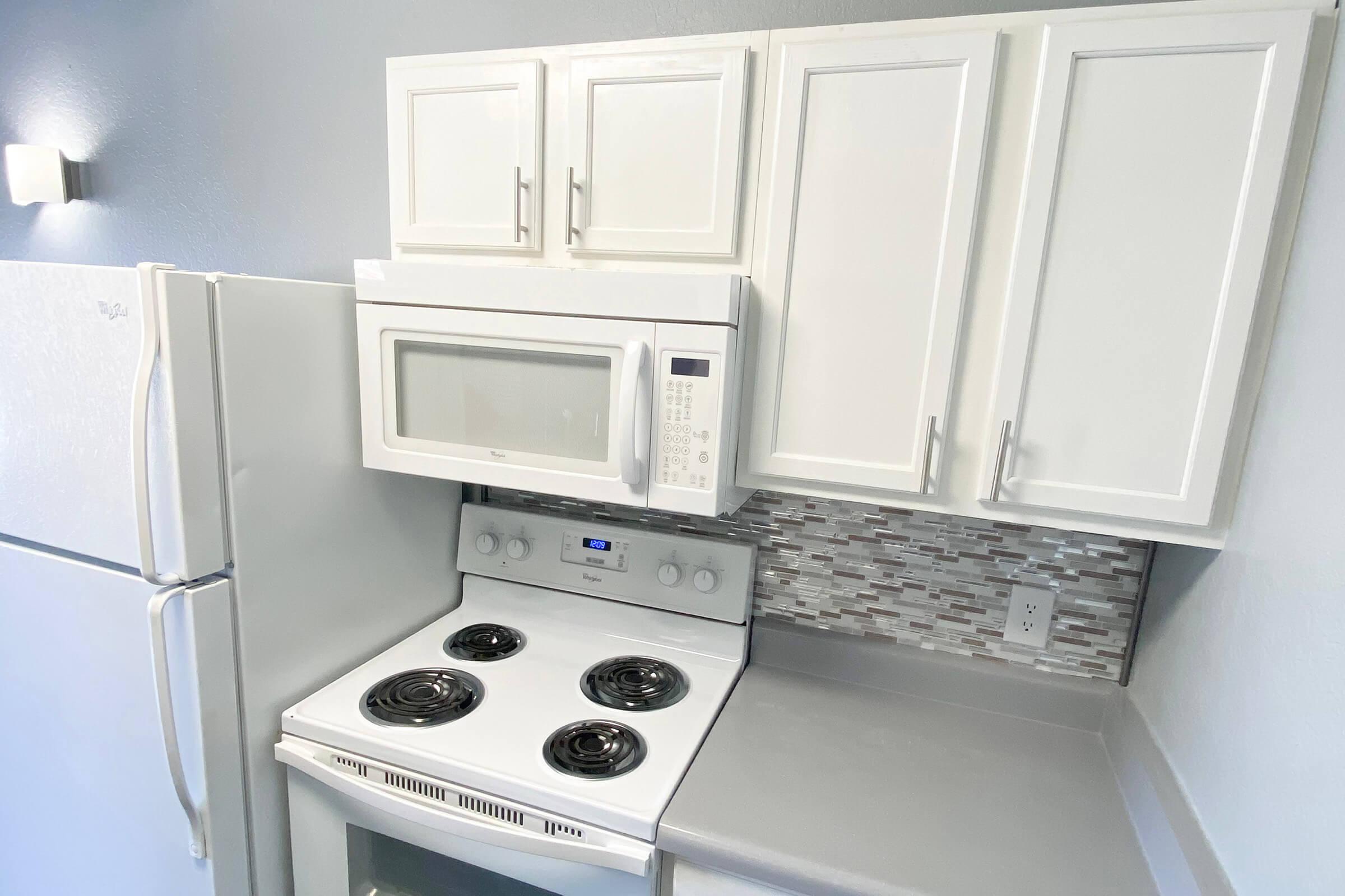 a microwave oven sitting on top of a stove