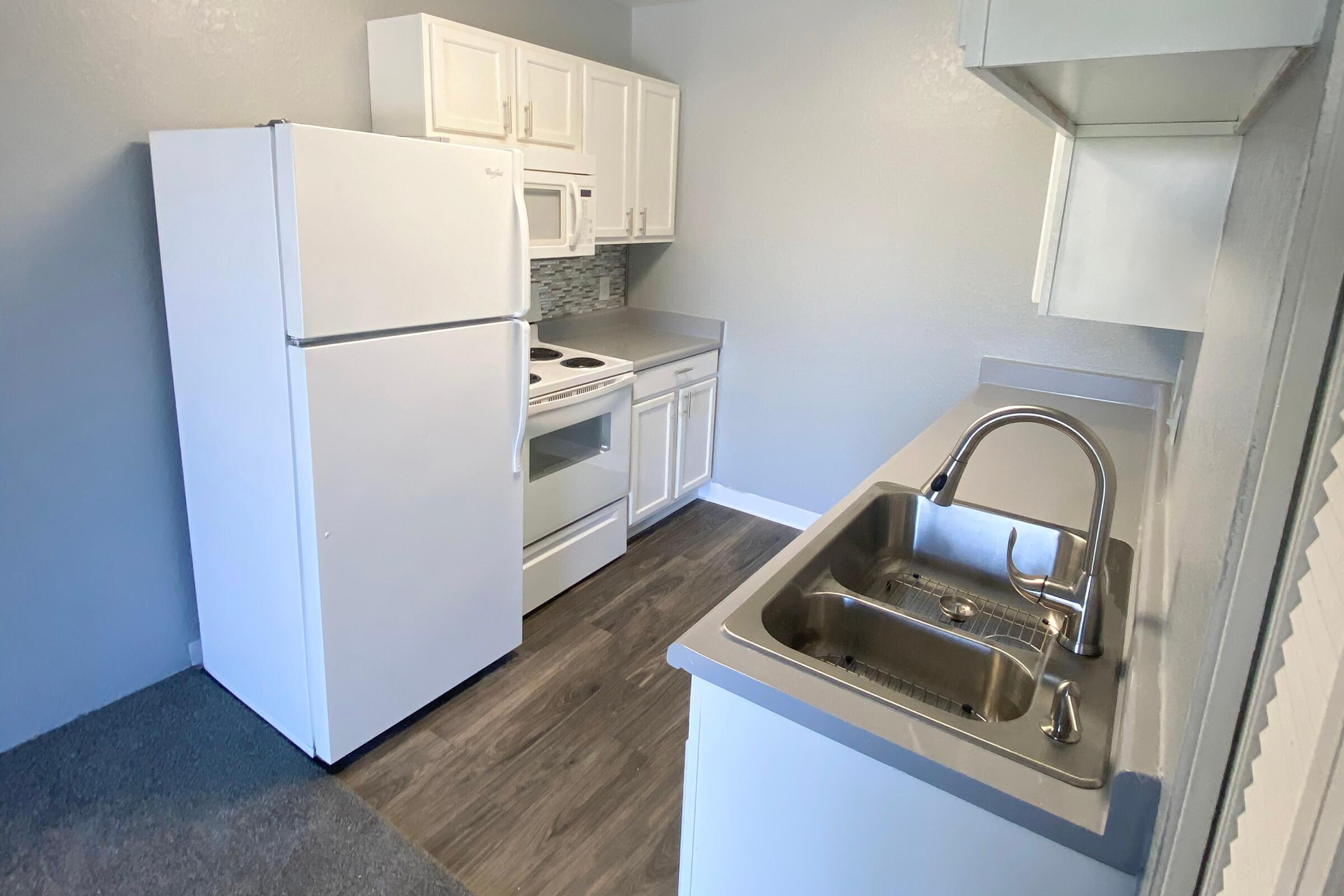 a kitchen with a stove top oven sitting inside of a refrigerator