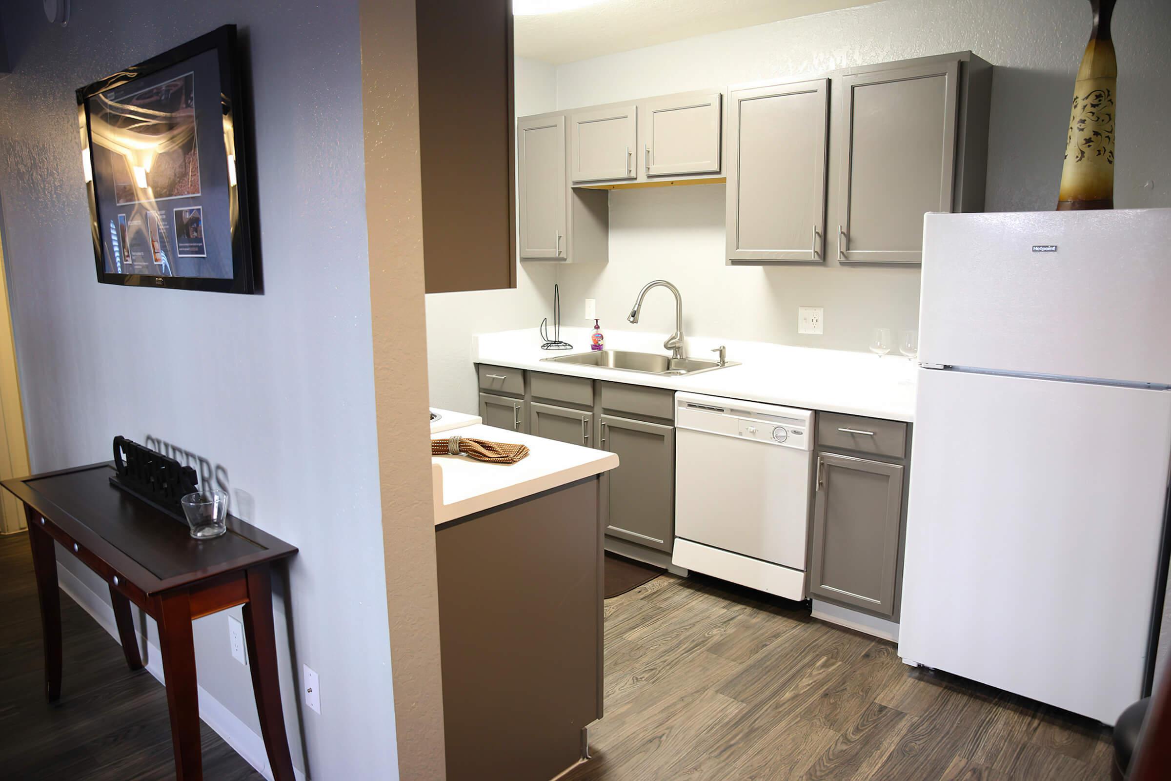 a kitchen with a sink and a mirror