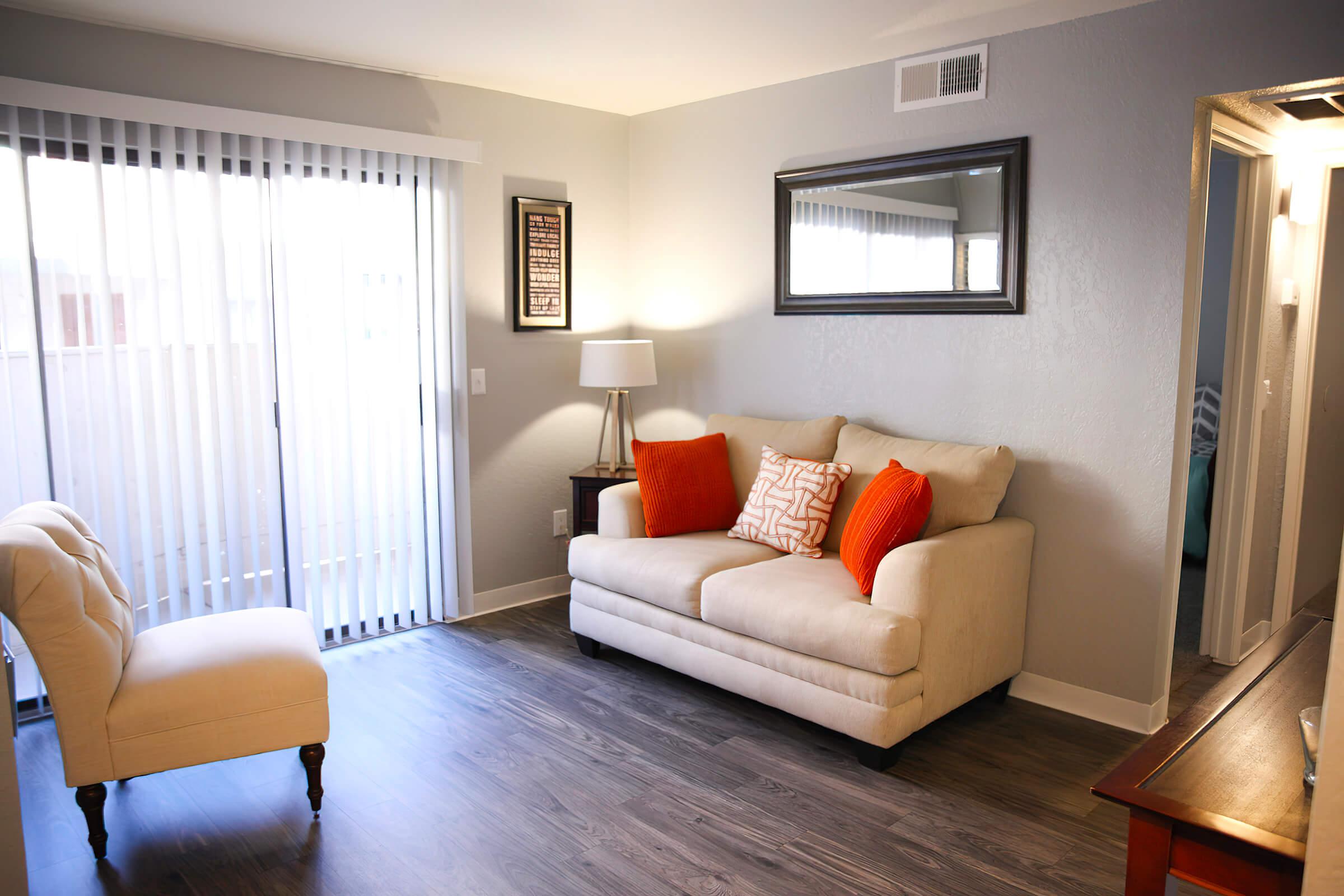 a living room filled with furniture and a large window