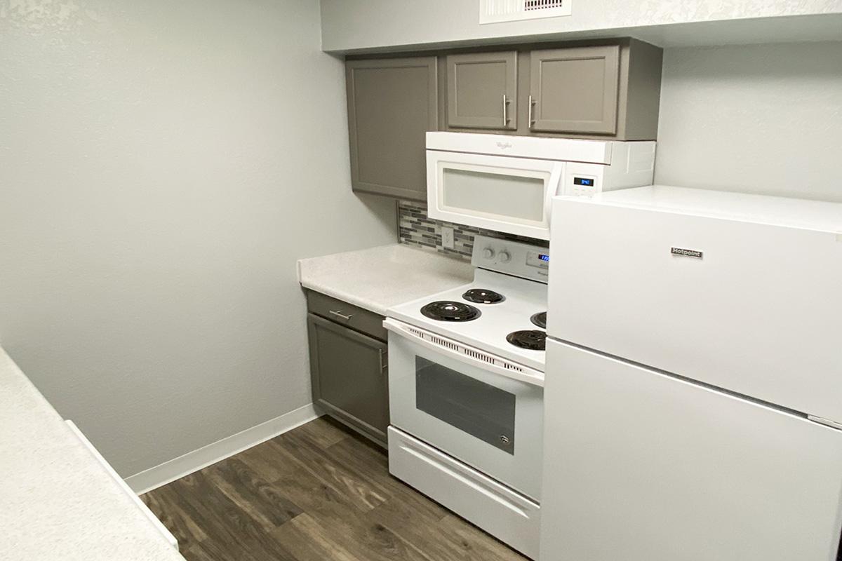 a stove top oven sitting inside of a kitchen