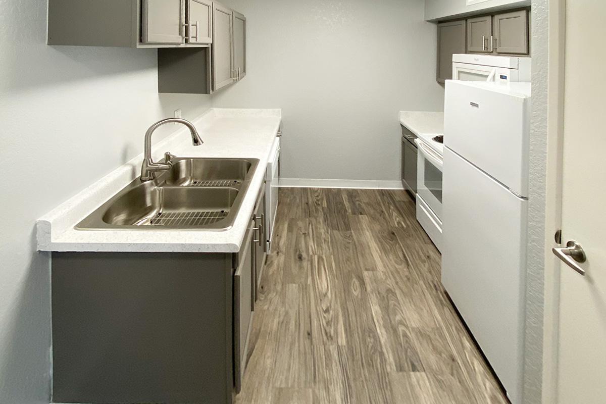 a kitchen with a sink and a mirror