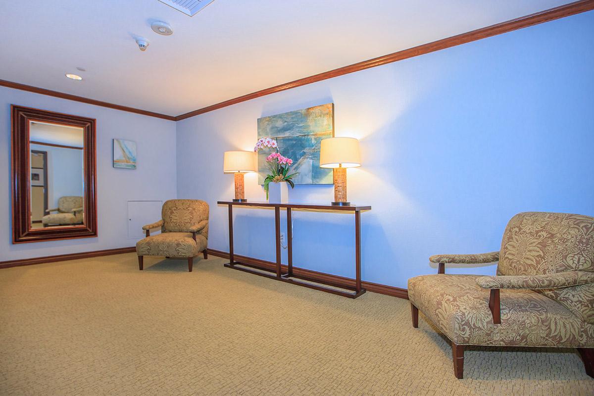 a living room with a bed and looking at the camera